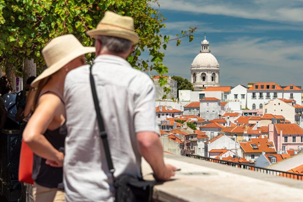 View over Alfama rooftops and the Tagus River from Miradouro de Santa Luzia, Lisbon