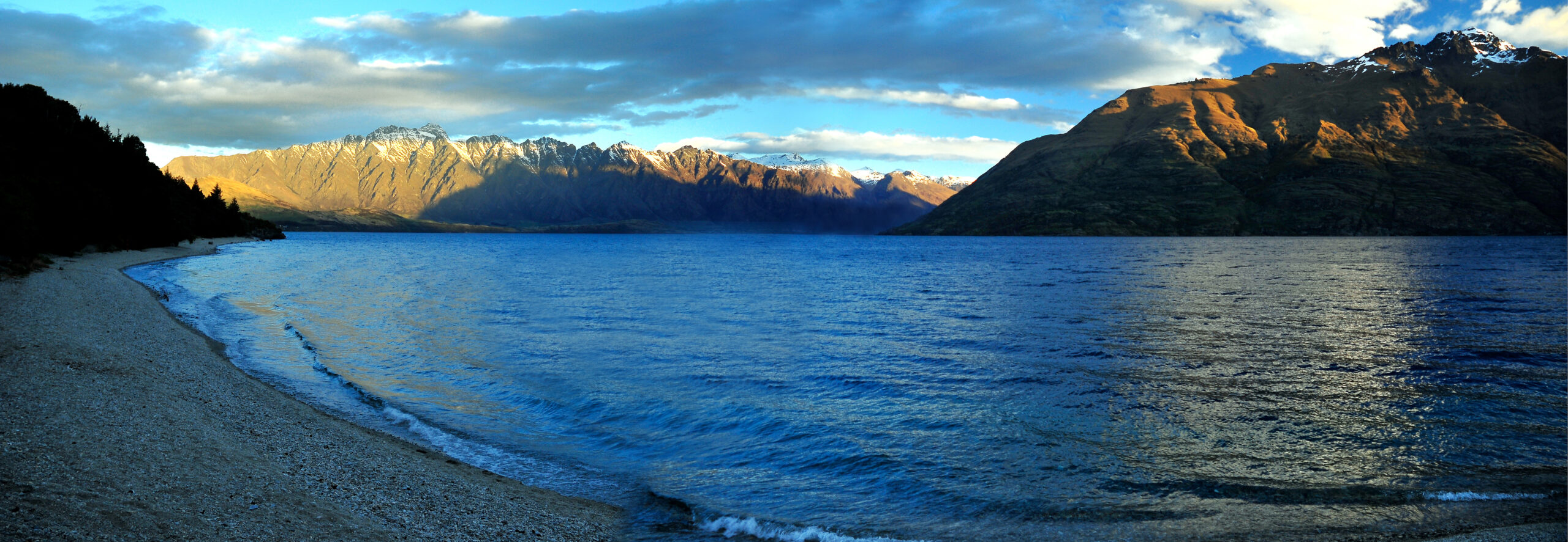 Panoramic view of Queenstown on the shores of Lake Wakatipu with The Remarkables mountain range behind