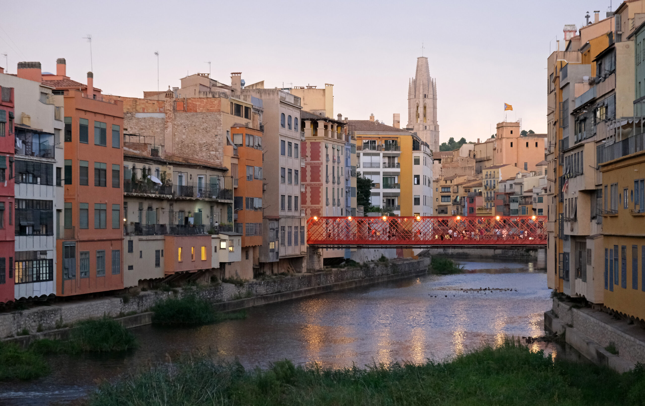 The Eiffel Bridge and colorful riverside houses along the Onyar river in Girona