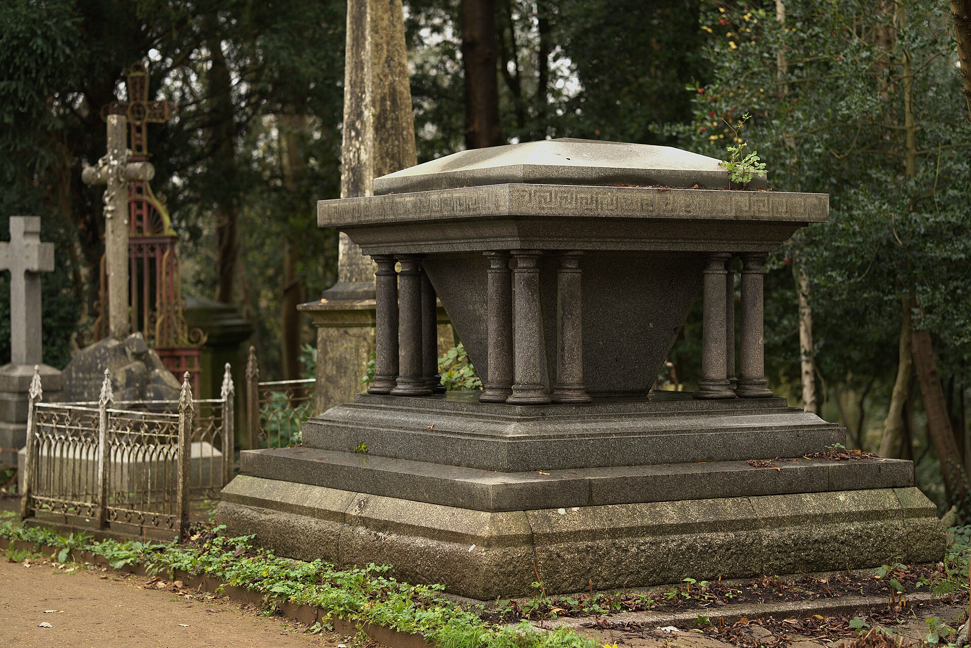 Victorian tomb monuments among trees at Highgate Cemetery, London
