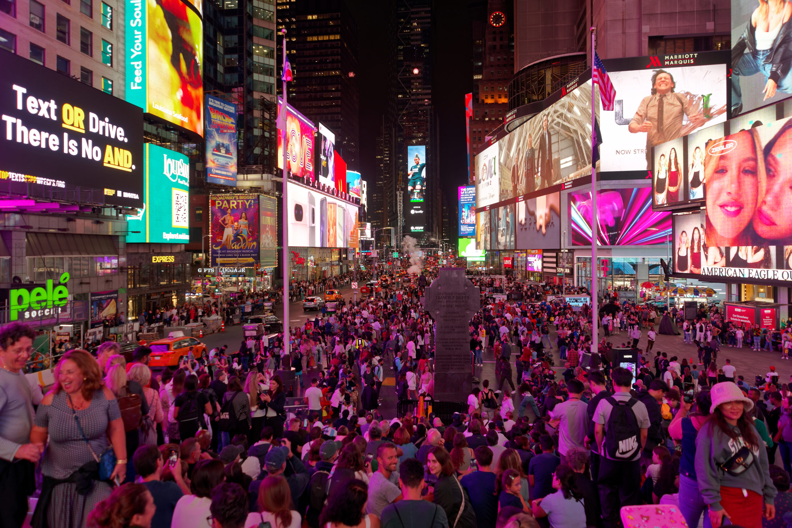Times Square at night with lit billboards