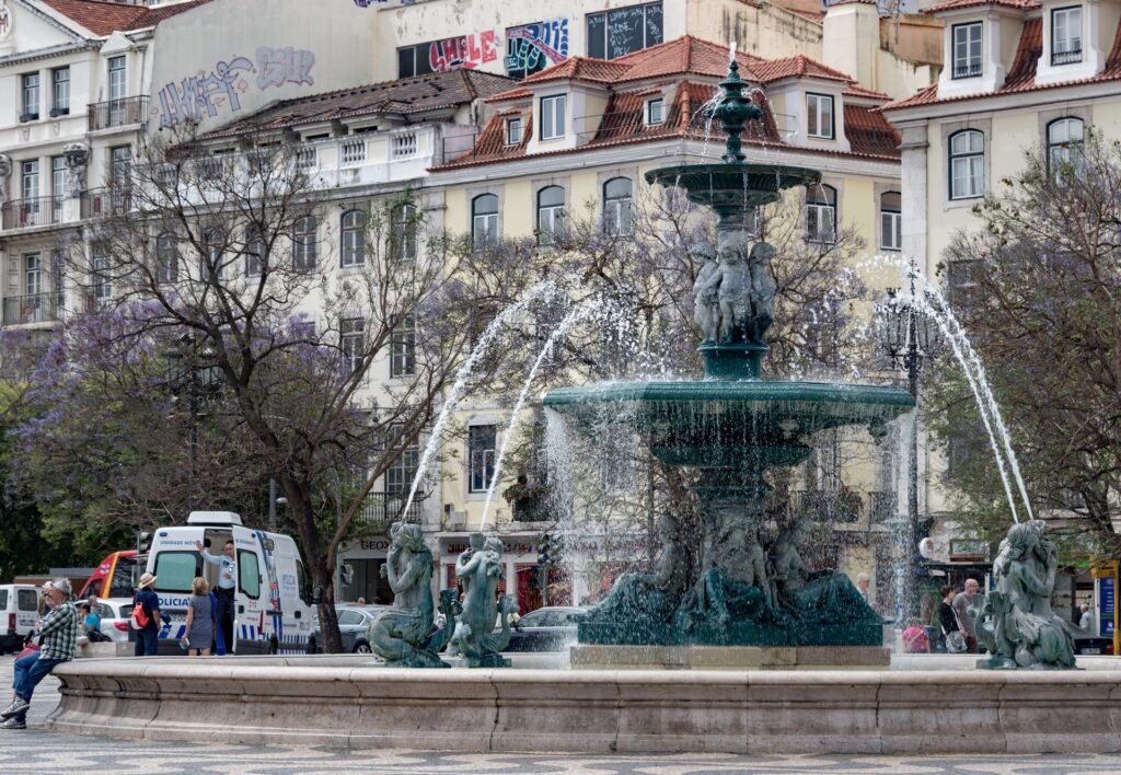 Baixa Pombalina streetscape in downtown Lisbon with São Jorge Castle hill in the distance