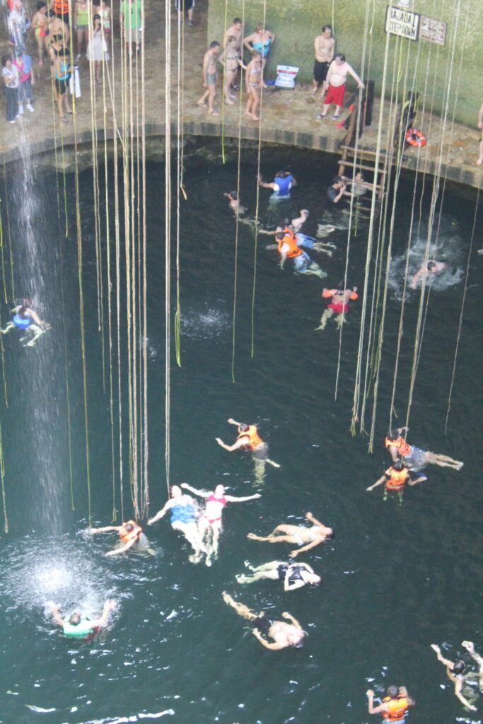 Cenote Ik Kil with sunlight streaming into turquoise water