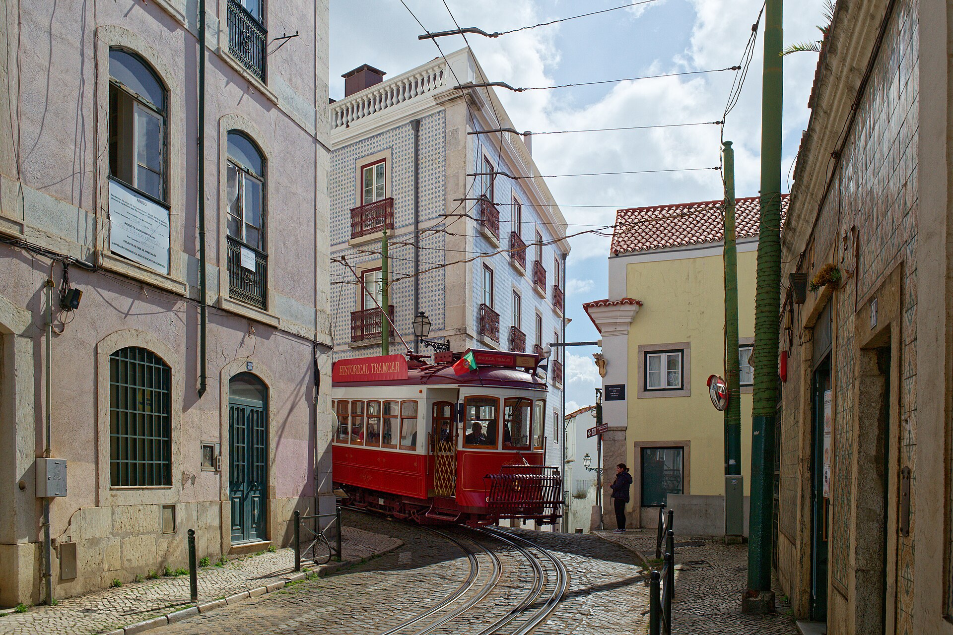 Historic tram on a cobbled street in Alfama, Lisbon