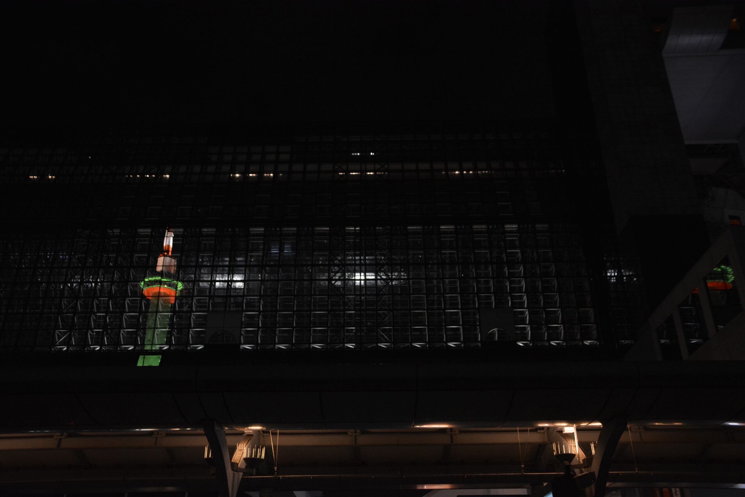 Kyoto Station building with Kyoto Tower reflected at night