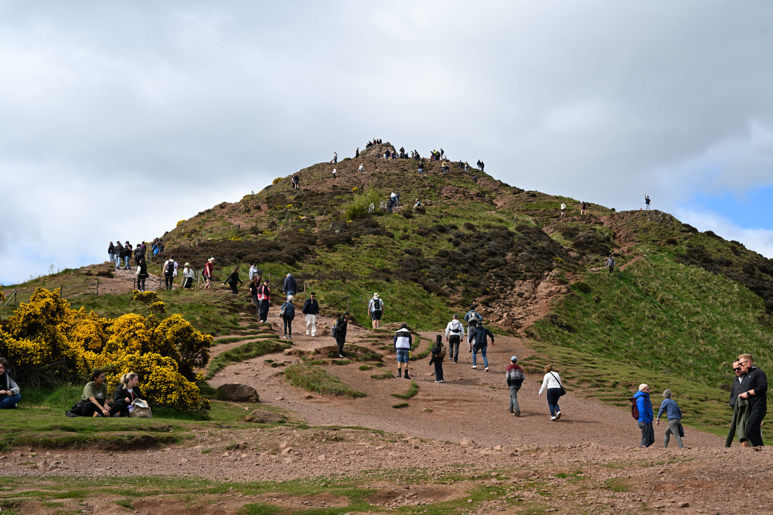 Hikers ascending the rocky trail up Arthur's Seat in Edinburgh's Holyrood Park