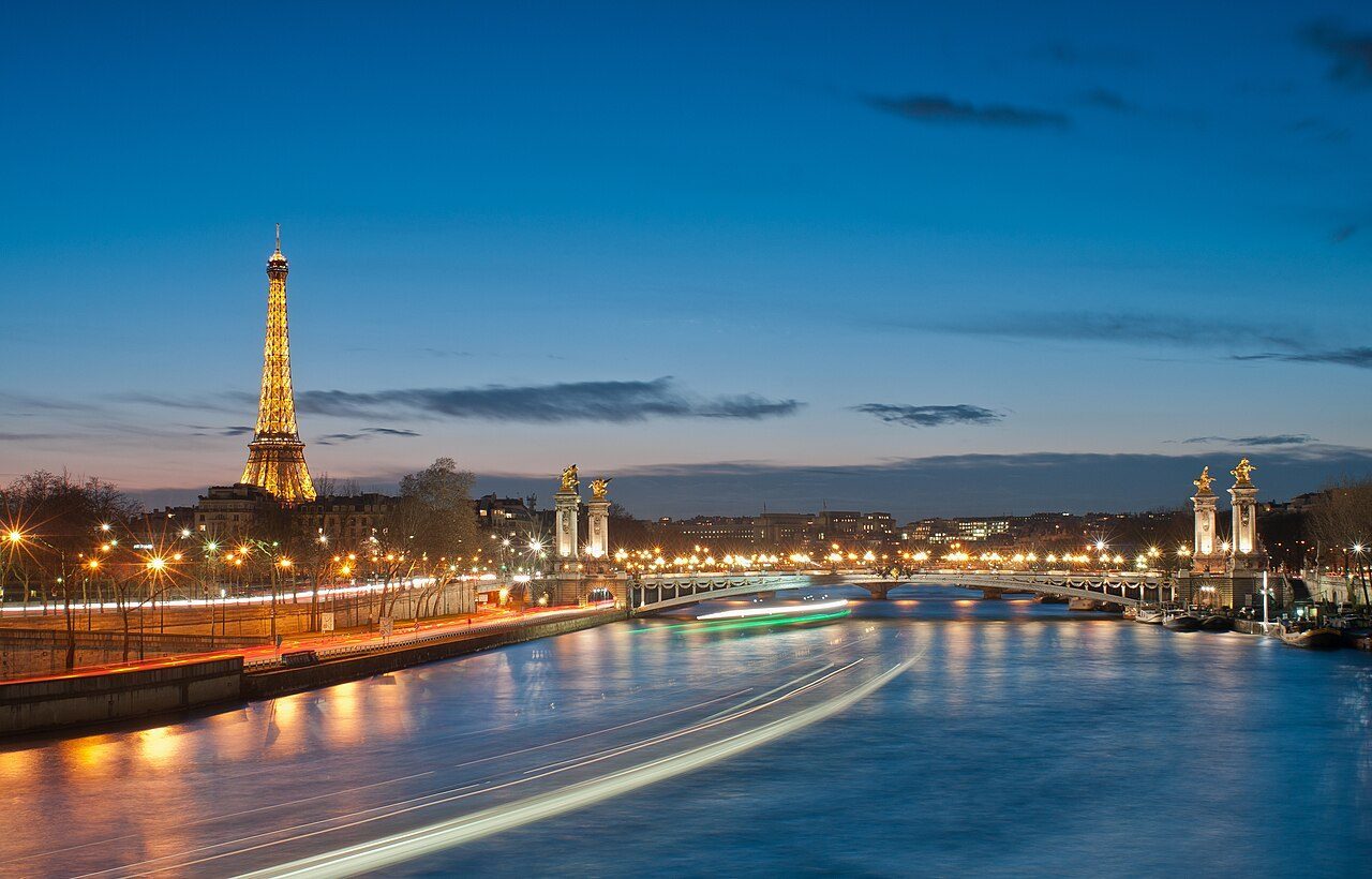Eiffel Tower and Pont Alexandre III sparkling at night in Paris