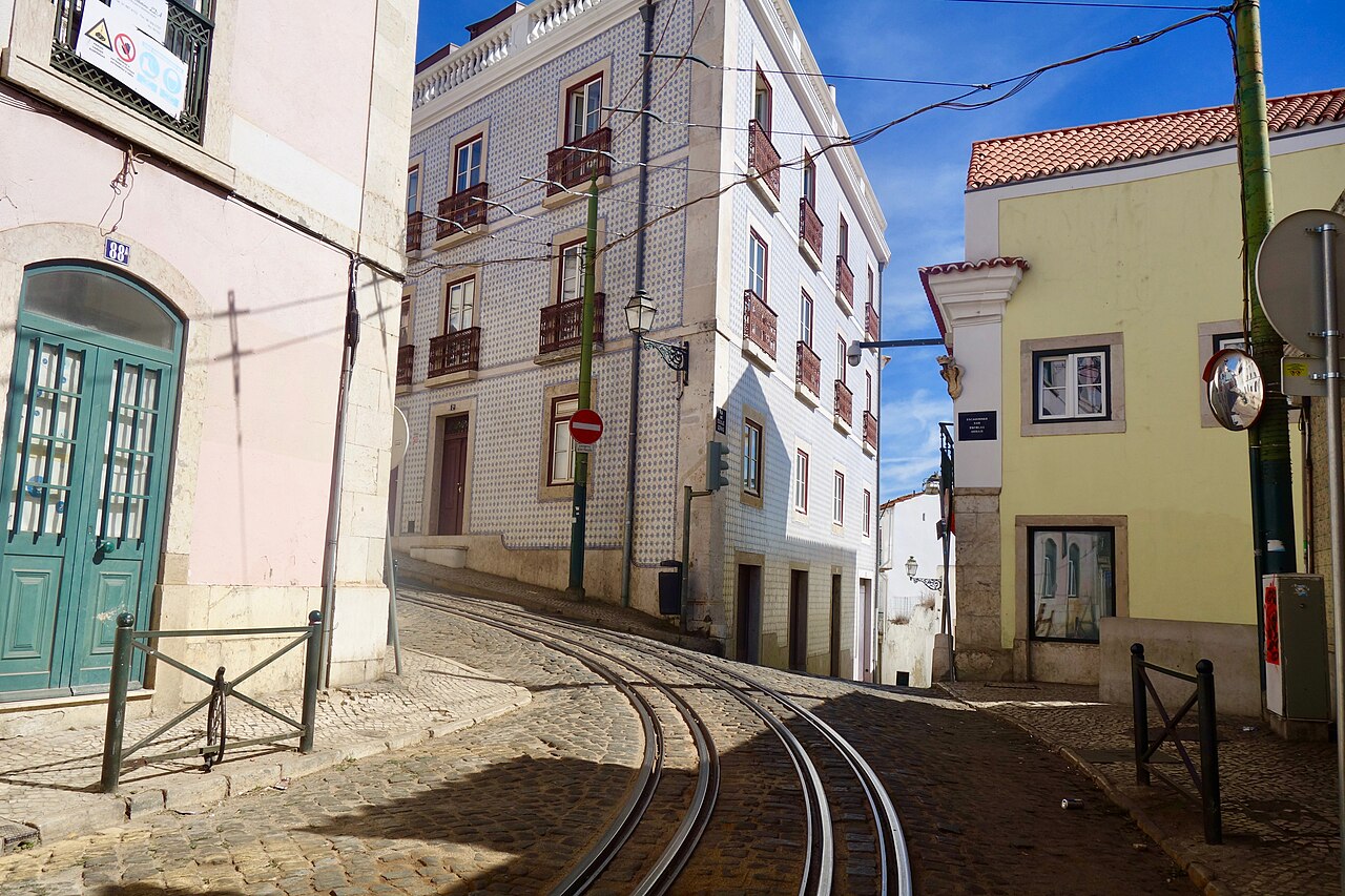 Yellow Tram 28 climbing through Lisbon's Alfama district