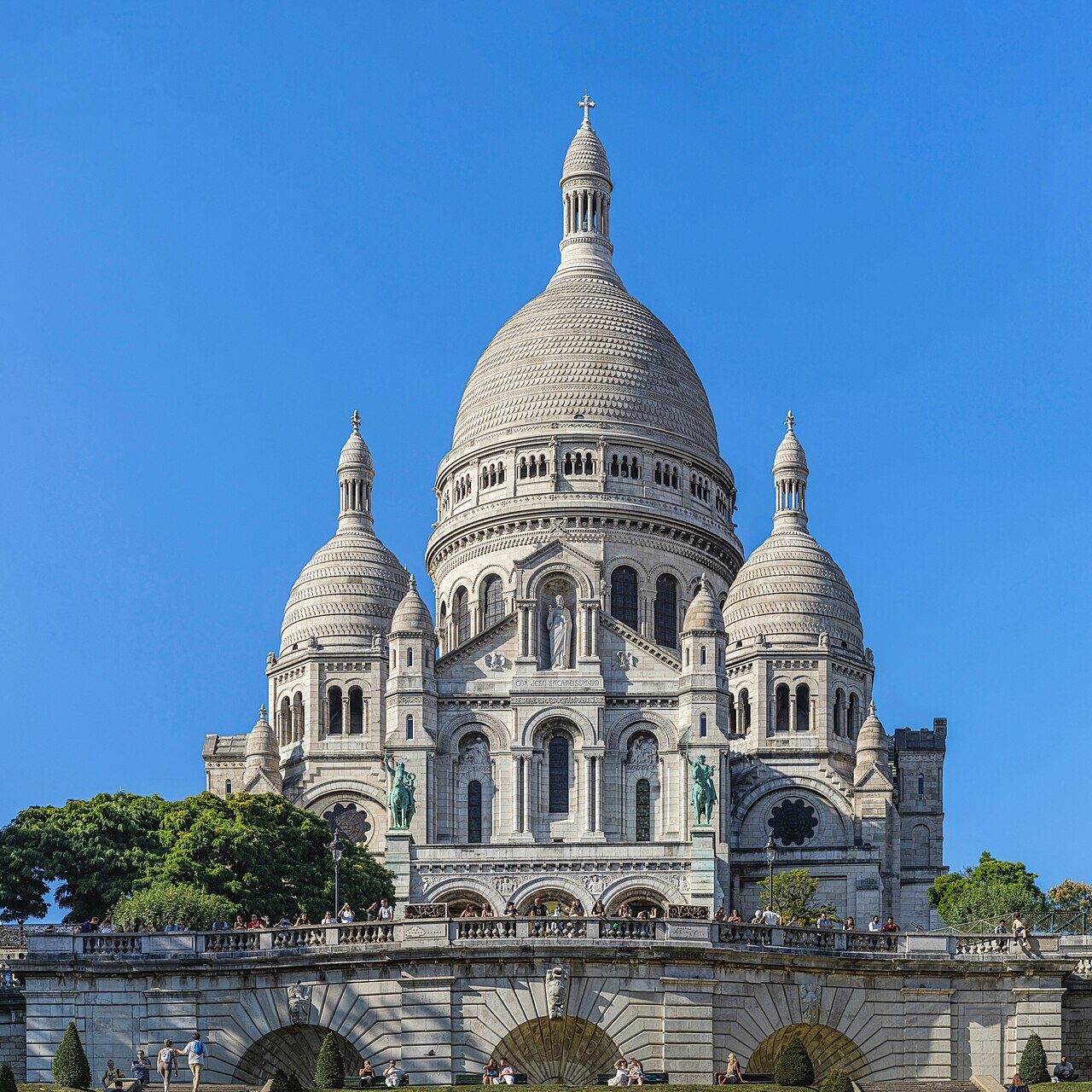White domes of Sacré-Cœur Basilica above Montmartre rooftops in Paris