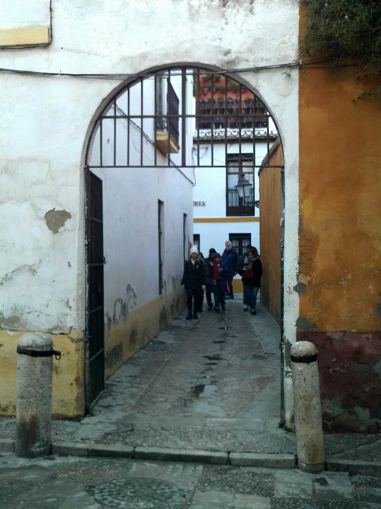 Where to stay in Seville: whitewashed alley in Santa Cruz