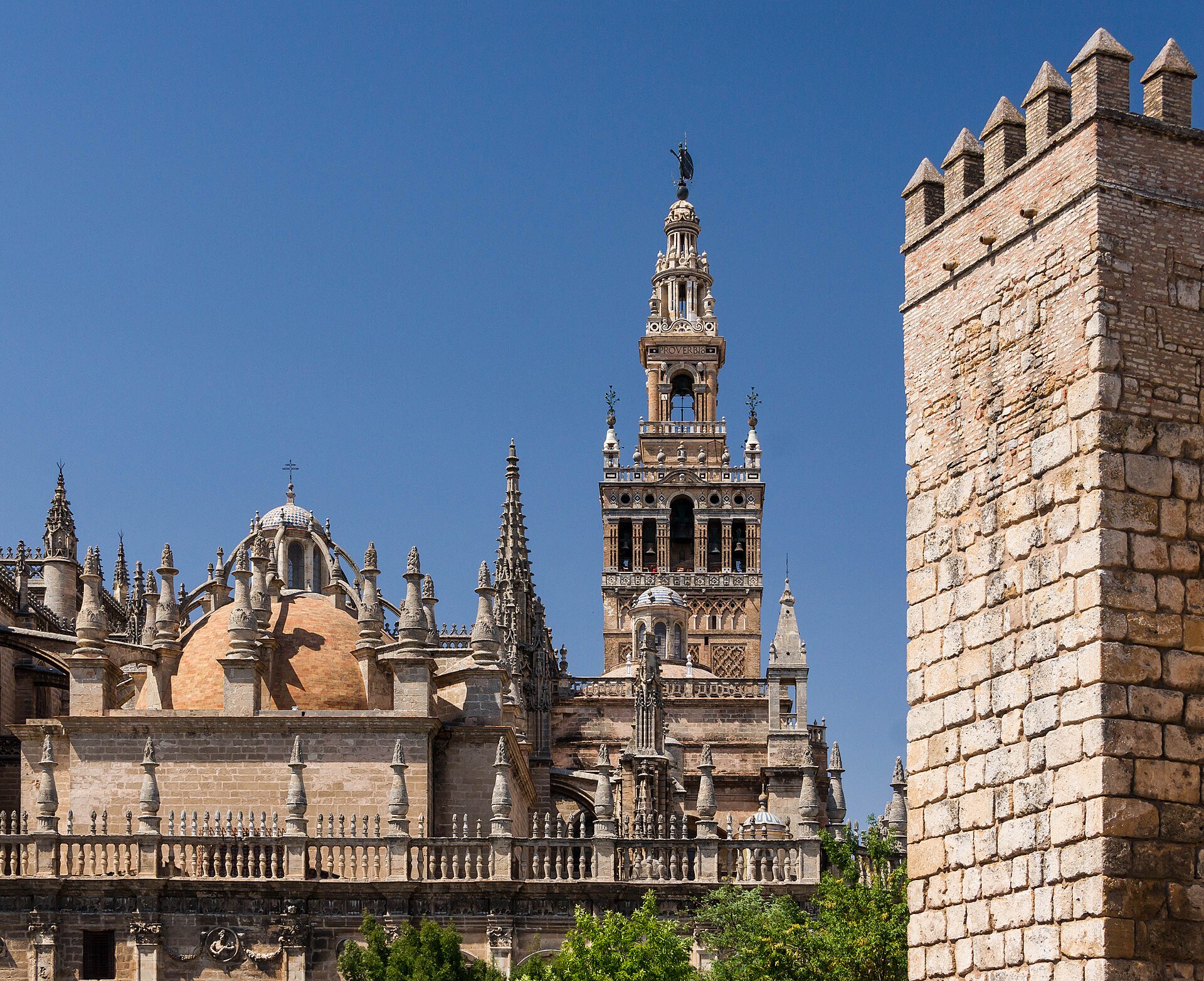 Seville Cathedral and the Giralda tower, with the Alcázar's battlements at right