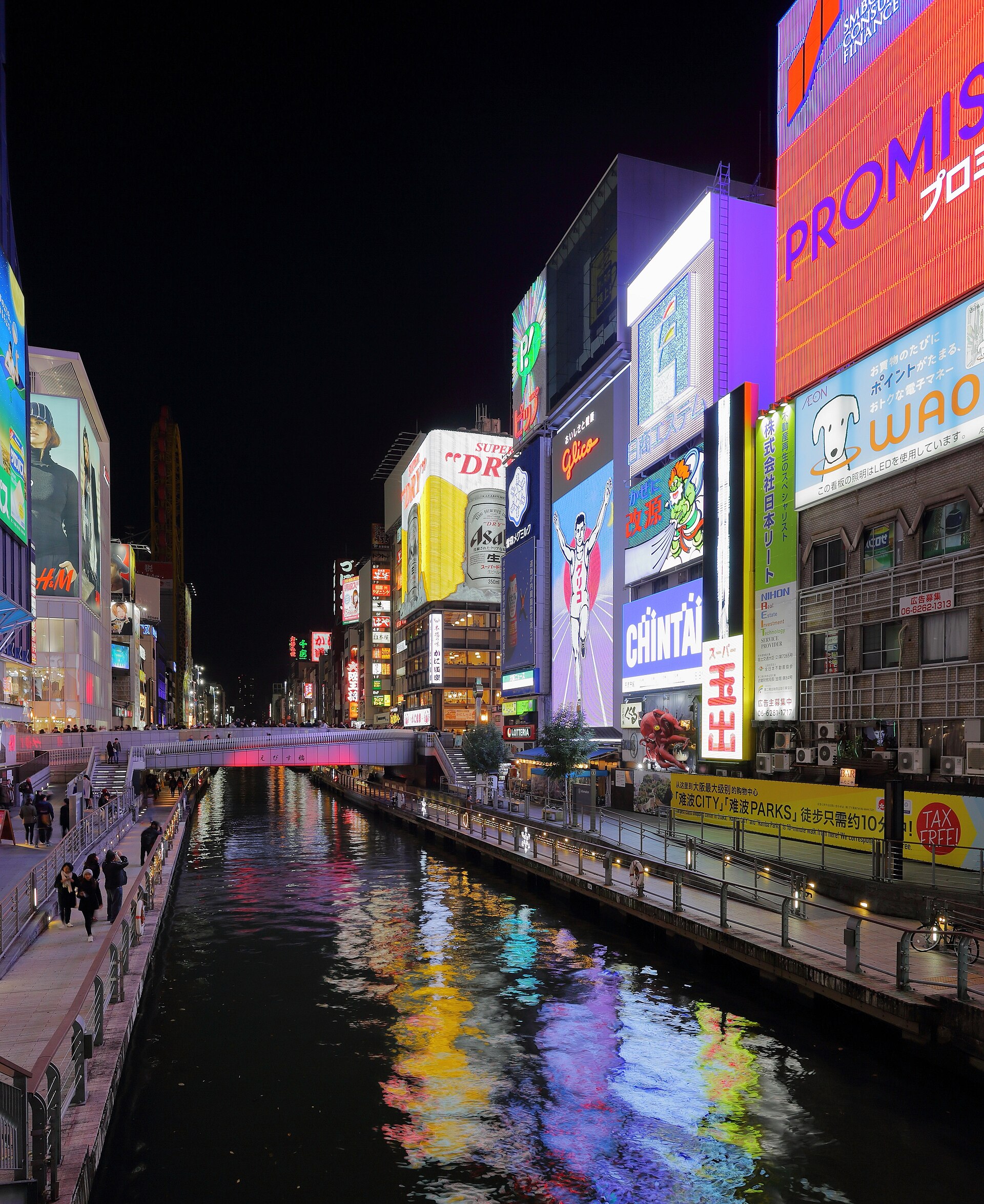 Neon signboards along the Dotonbori Canal at Ebisu Bridge in Osaka at night