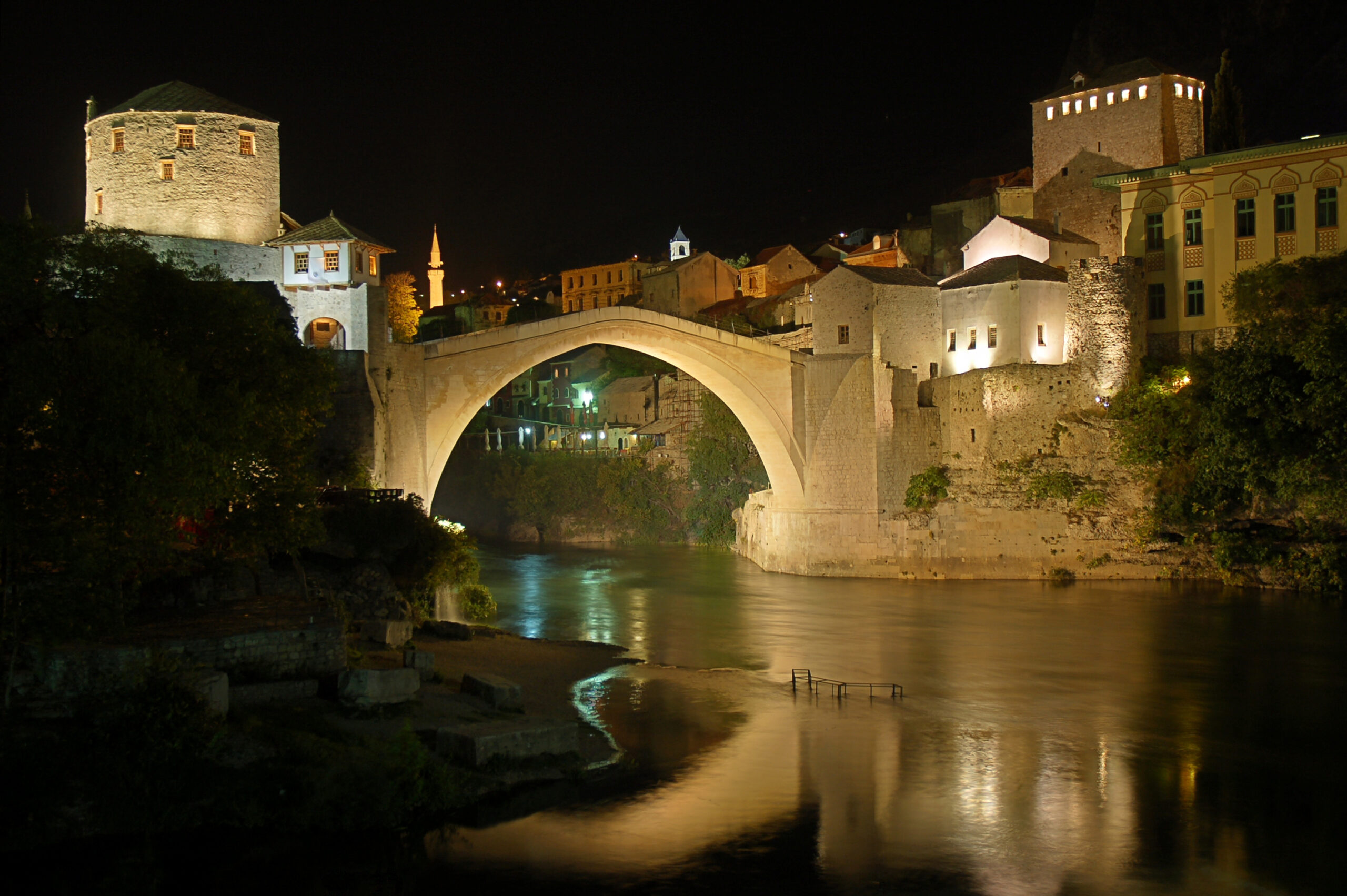 Stari Most bridge in Mostar illuminated at night over the Neretva River