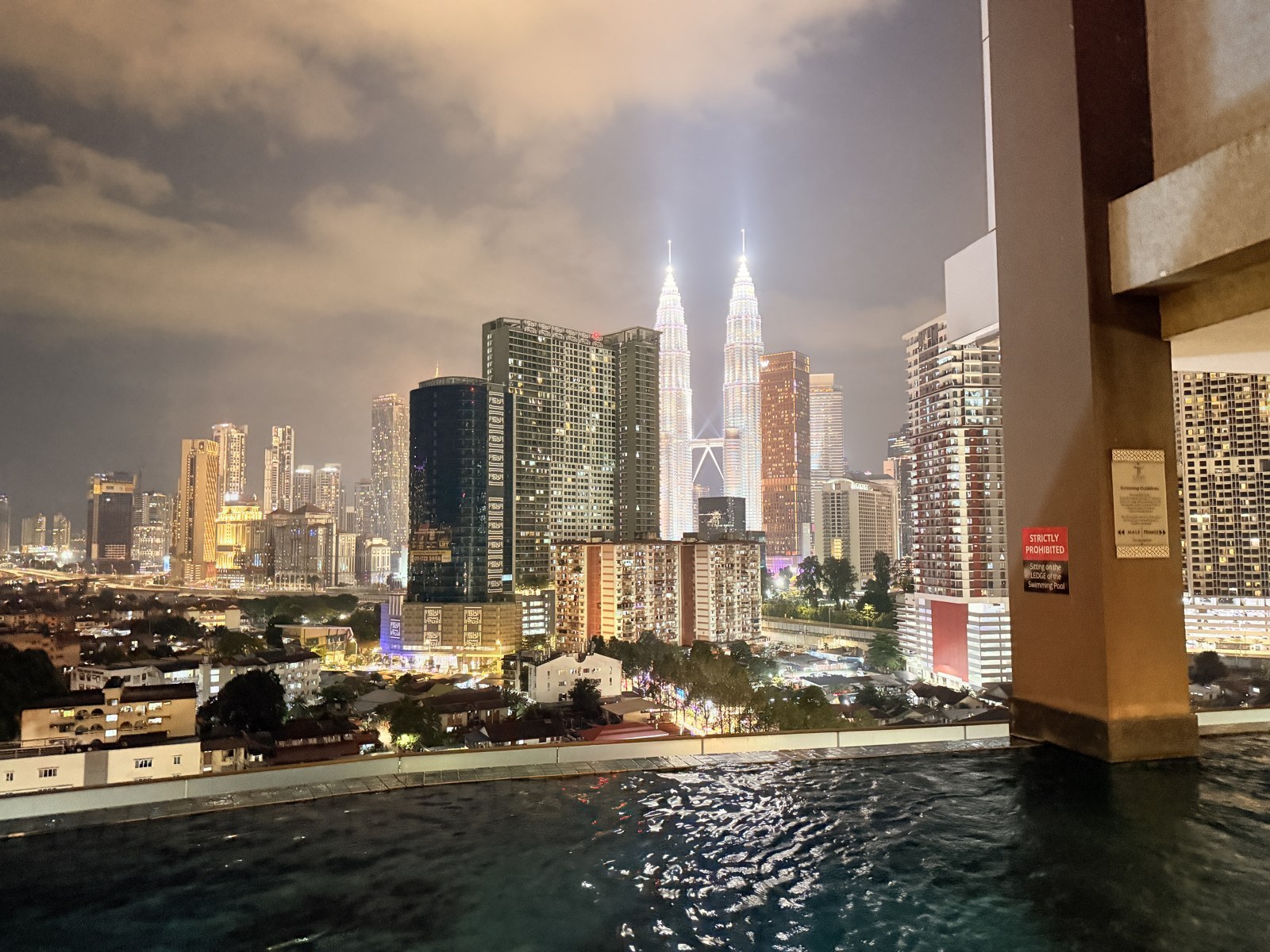 Petronas Towers Kuala Lumpur skyline at night with the illuminated twin towers