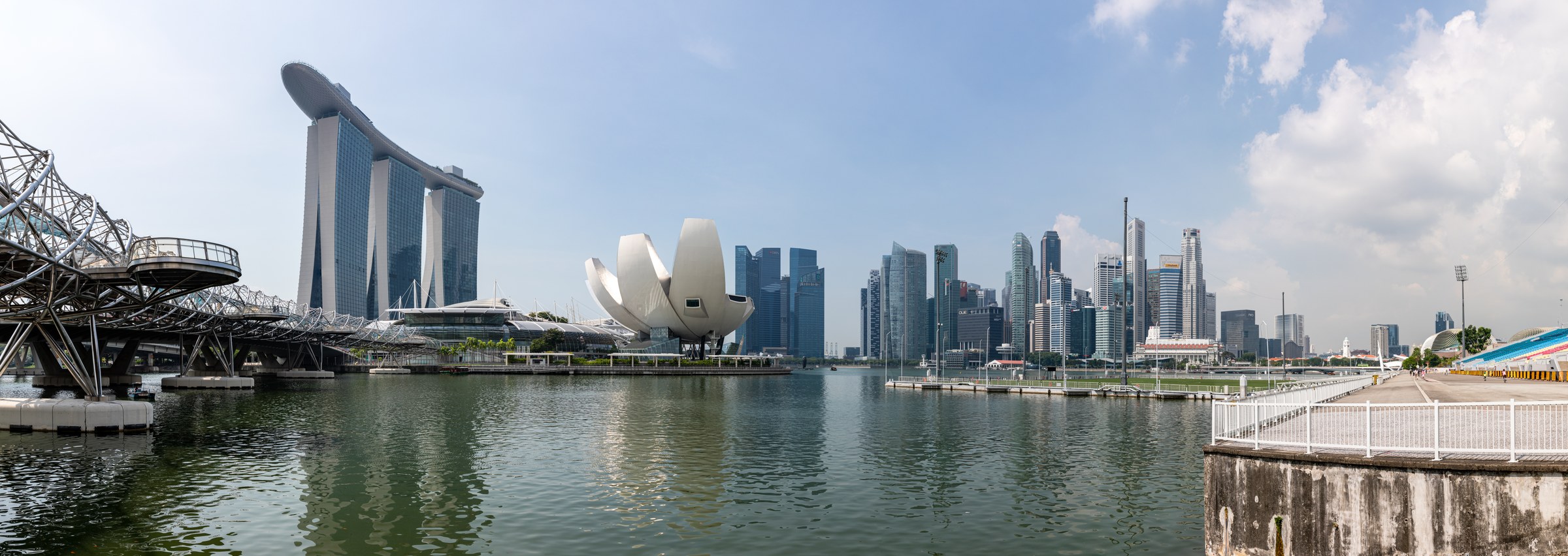 Singapore Marina Bay skyline with Marina Bay Sands, ArtScience Museum and Helix Bridge in daylight