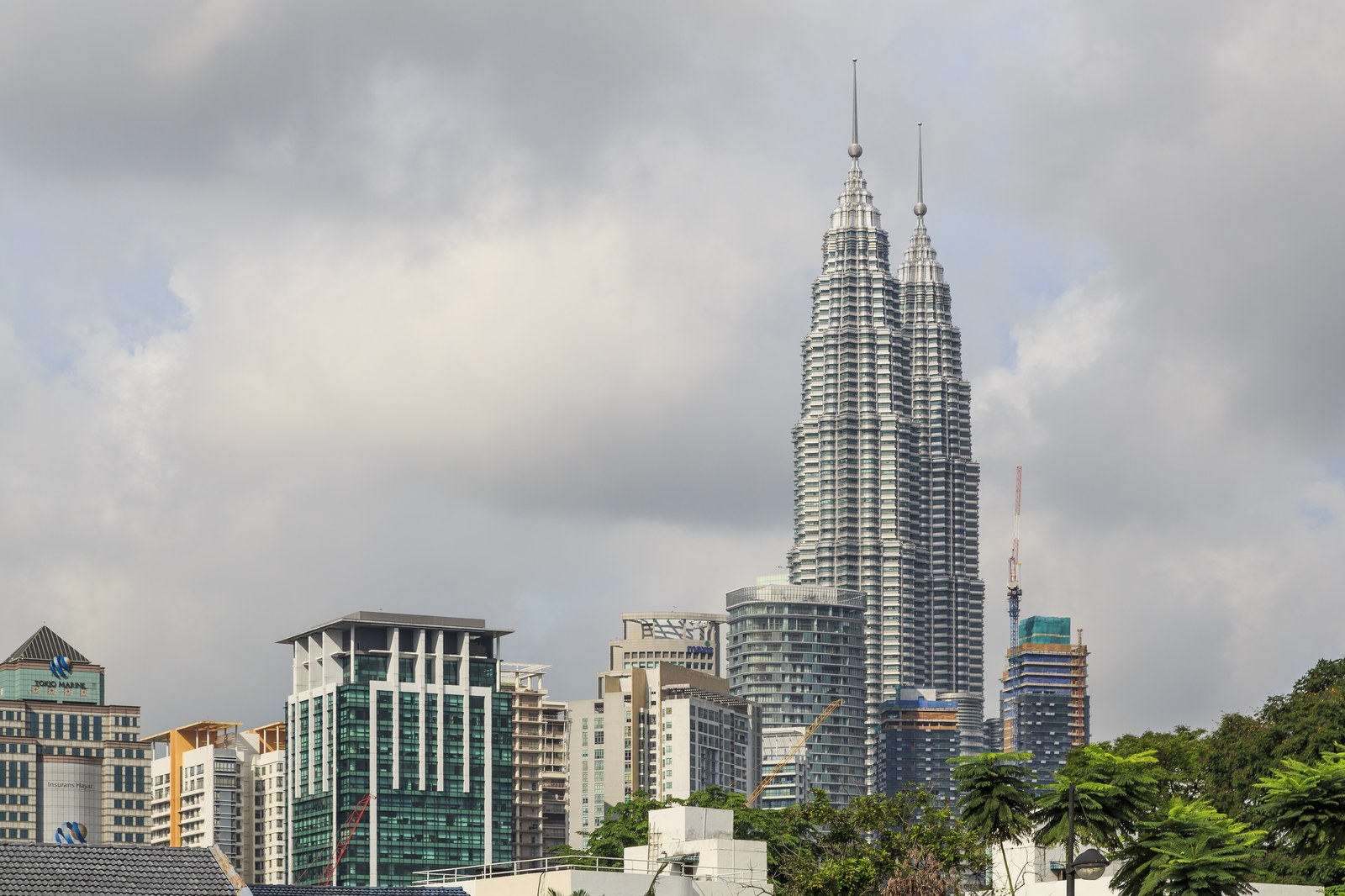 Petronas Twin Towers rising above Kuala Lumpur in daylight