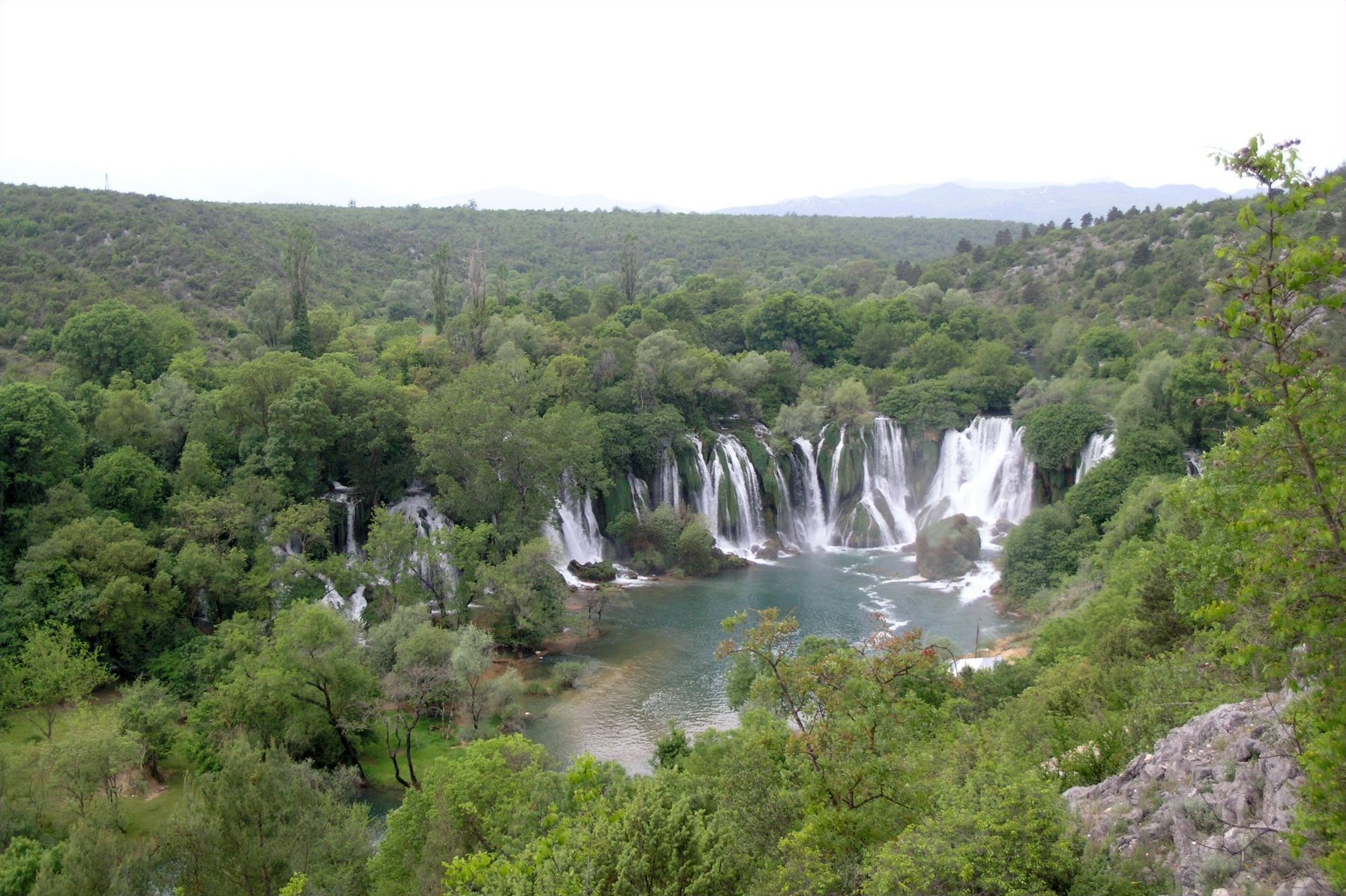 Kravice Waterfalls cascading into a green basin on the Trebižat River in Bosnia and Herzegovina
