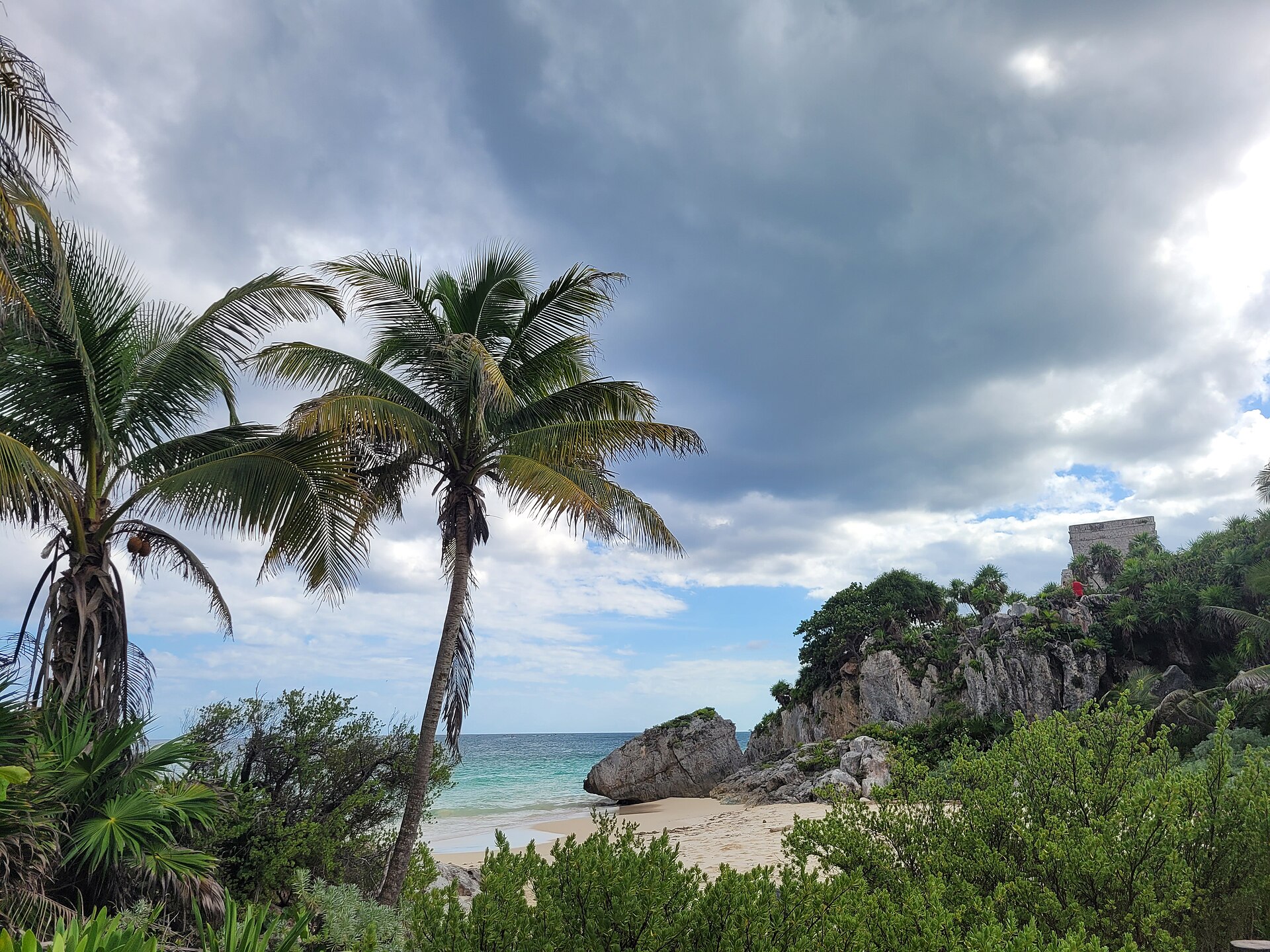 Maya ruins at Tulum above the beach and palms