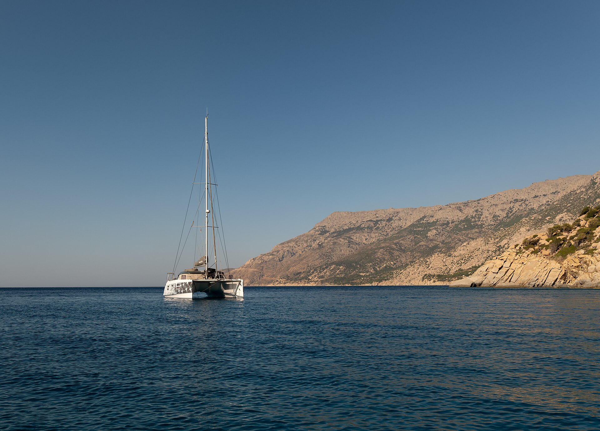 Santorini catamaran cruise sailing boat anchored in the Aegean Sea