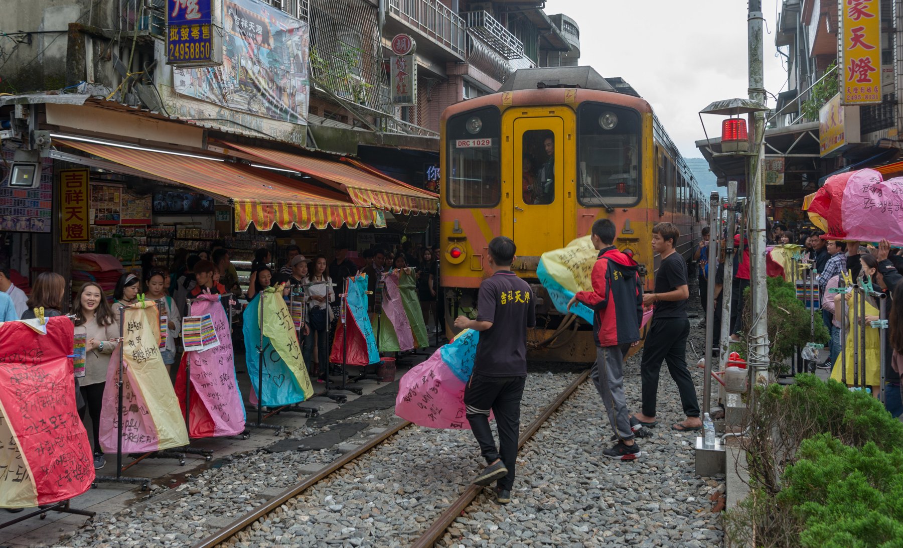 Sky lanterns rising above Shifen Old Street and its railway tracks in Taiwan