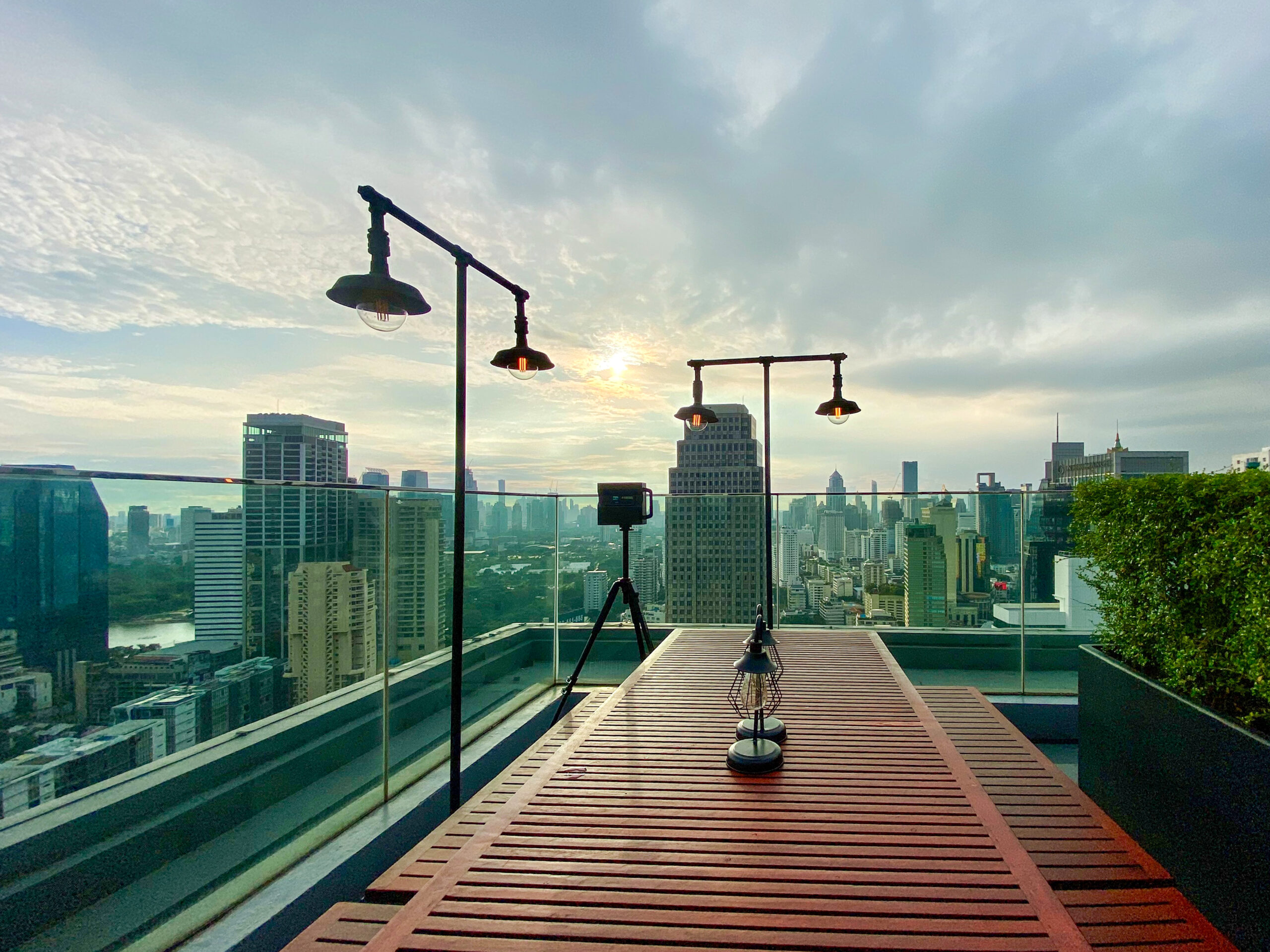 View over Bangkok rooftops and skyscrapers from a high rooftop bar