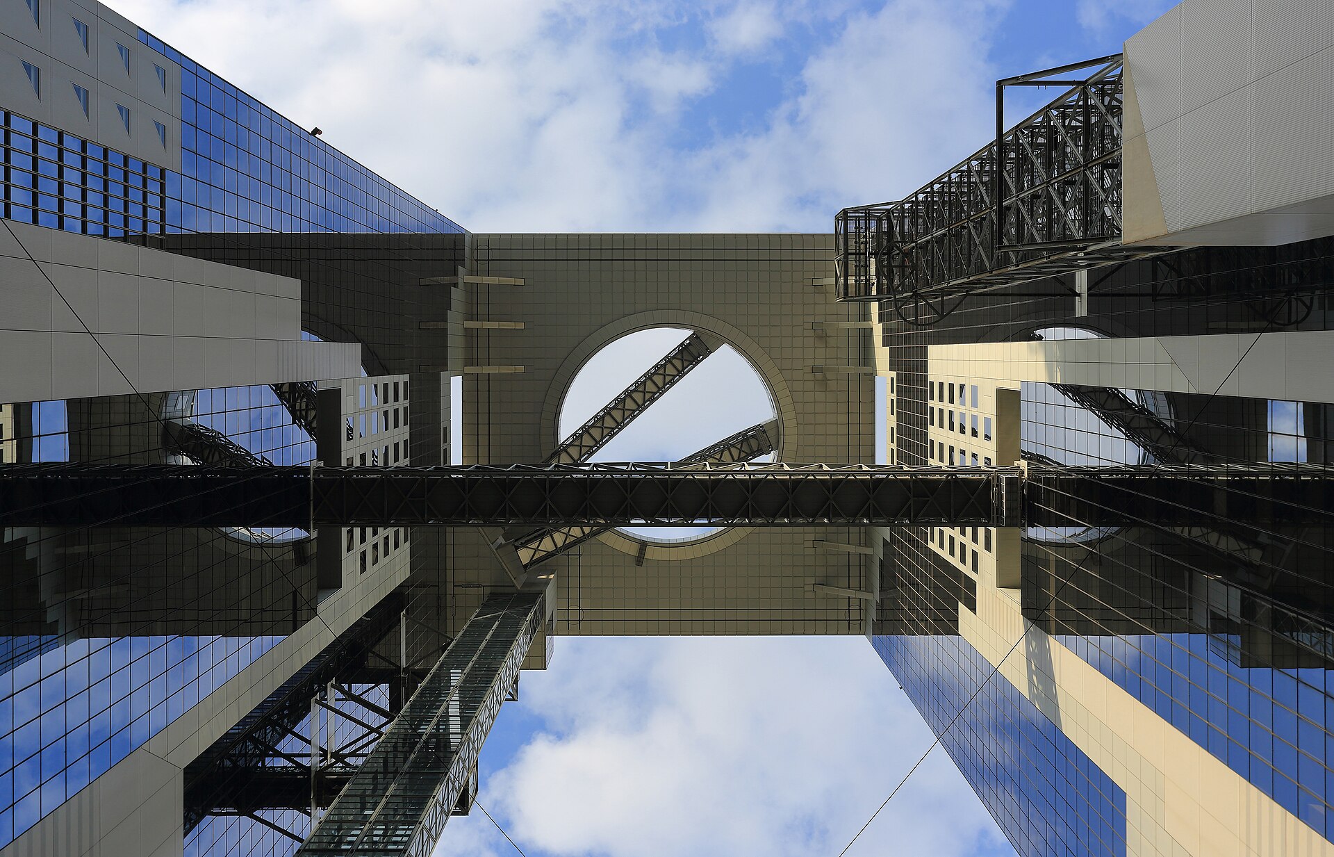 Looking up at the twin towers and sky bridge of the Umeda Sky Building in Osaka
