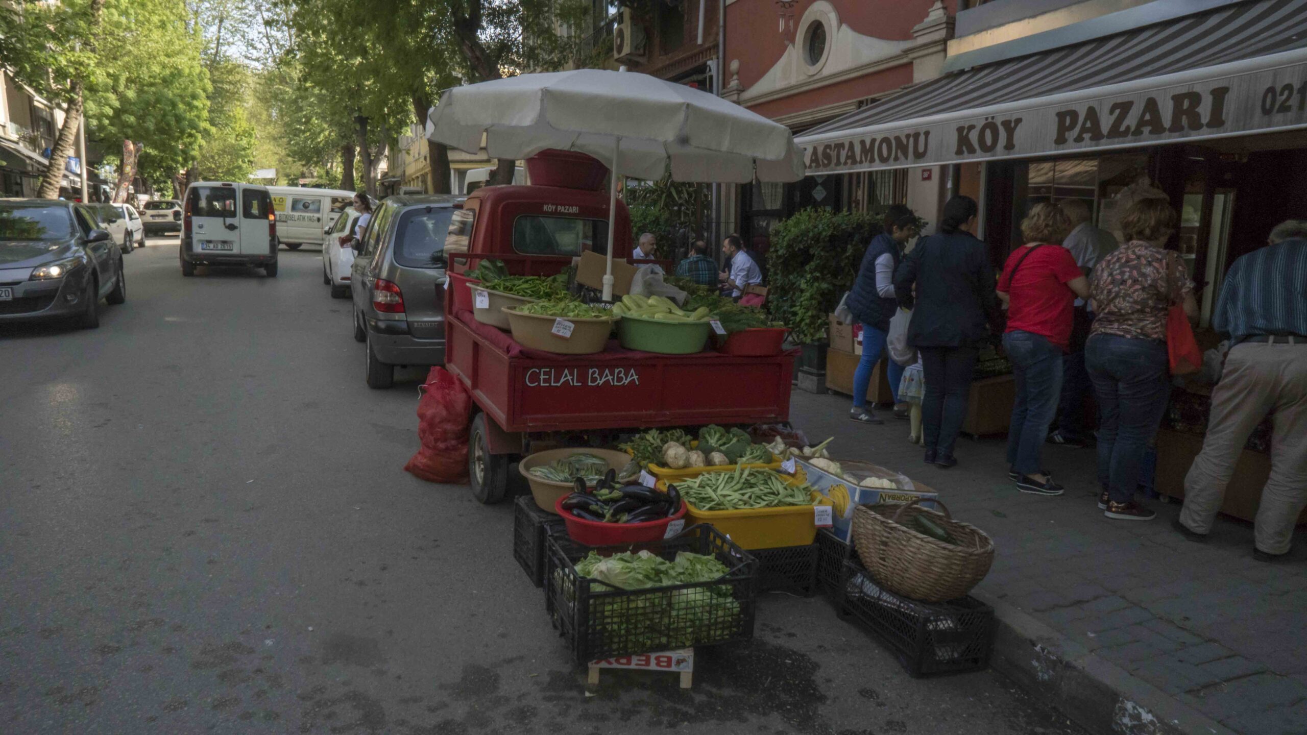 Icadiye Street in Kuzguncuk, lined with restored old wooden houses, shops, and cafe terraces.