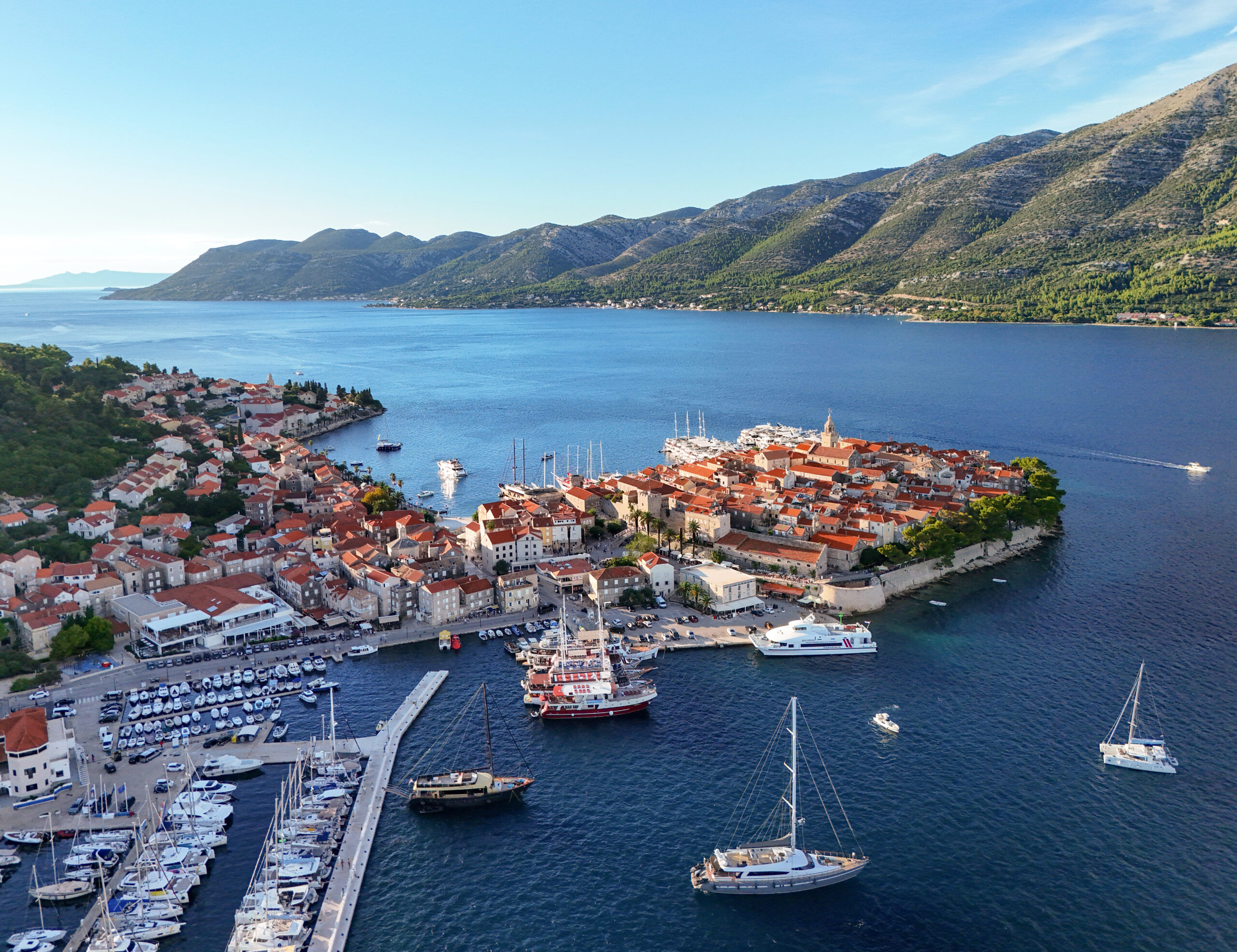 Korčula old town with its red rooftops and towers seen across the water