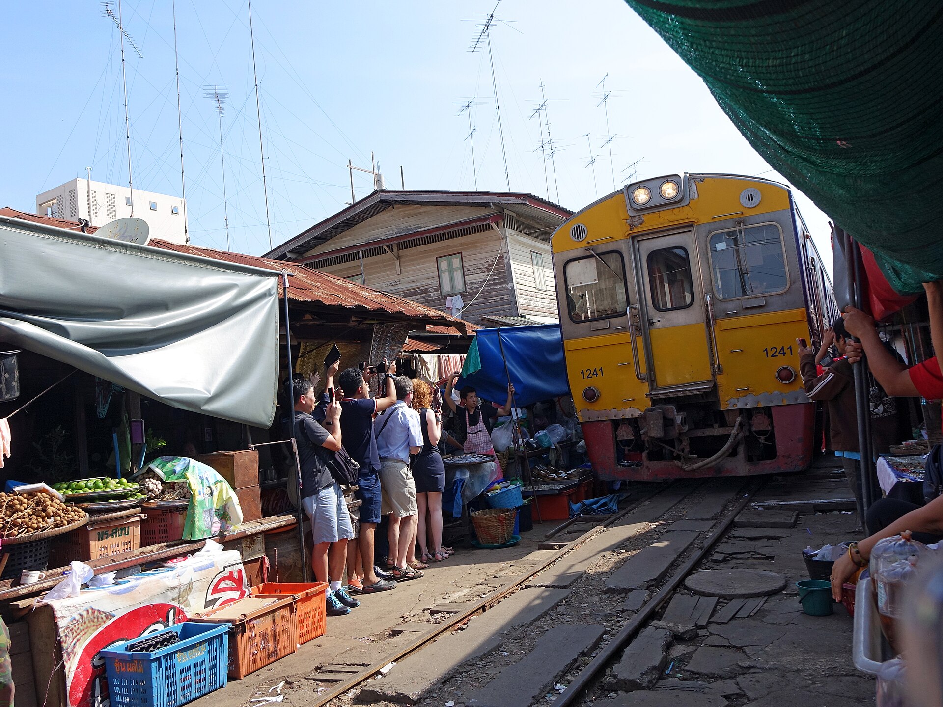 Train passing through Maeklong Railway Market, Thailand