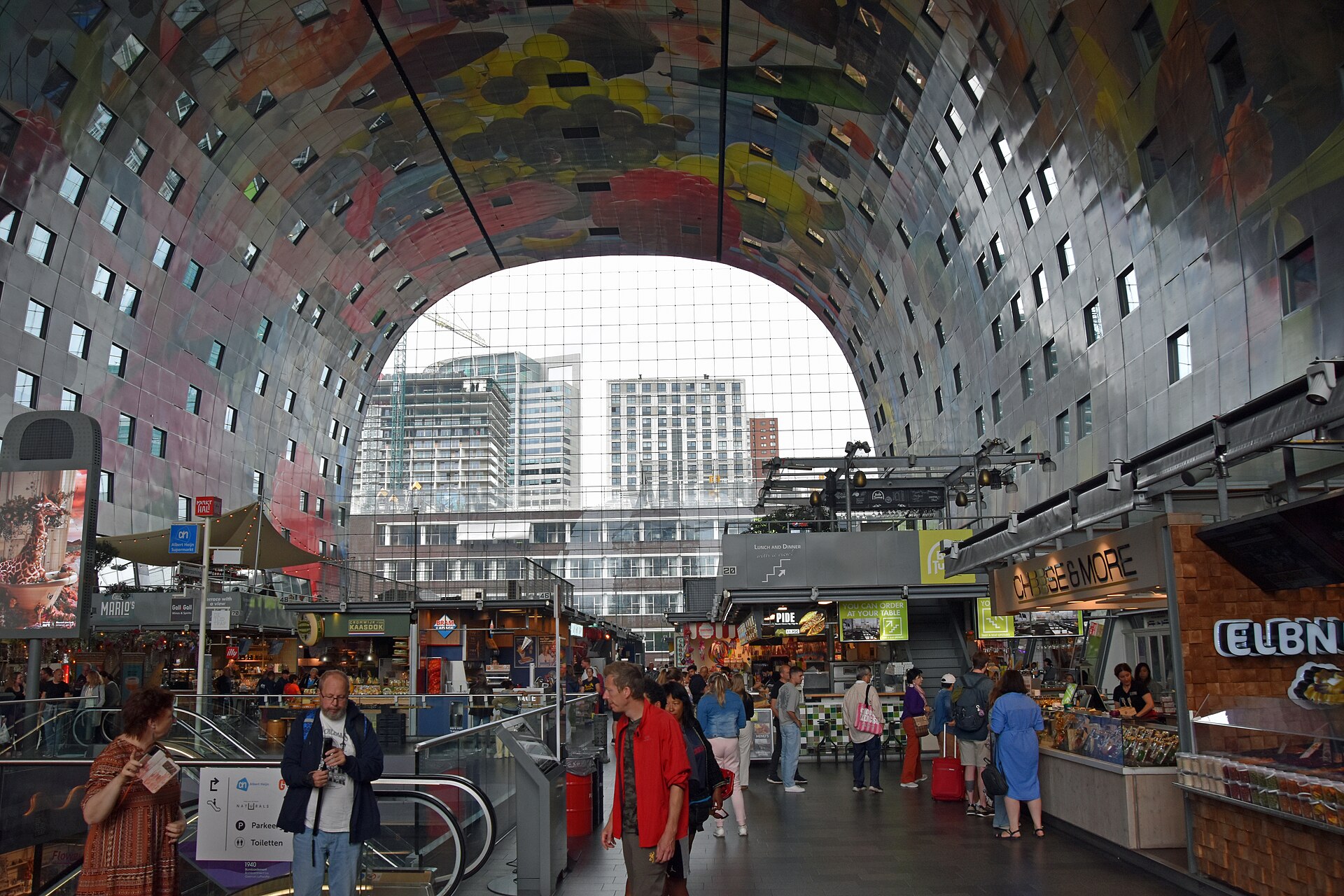Inside the Markthal in Rotterdam, with its colourful arched ceiling above the food stalls