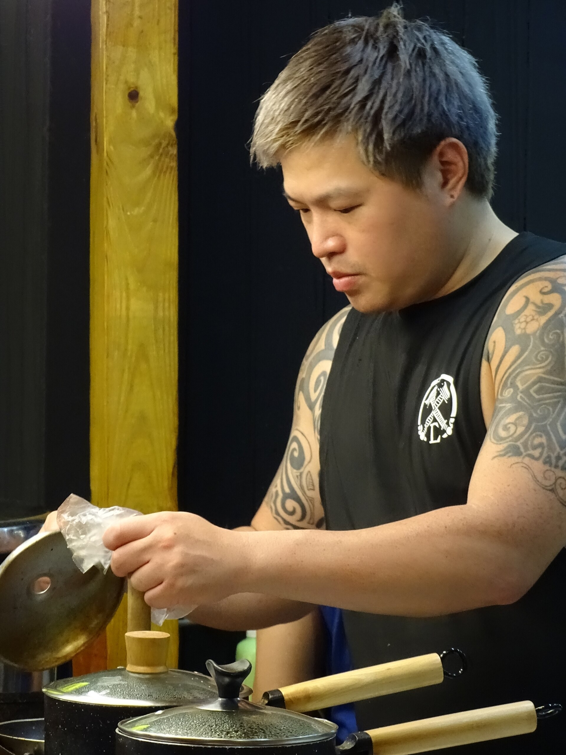 A food vendor serving customers at Shilin Night Market in Taipei, Taiwan