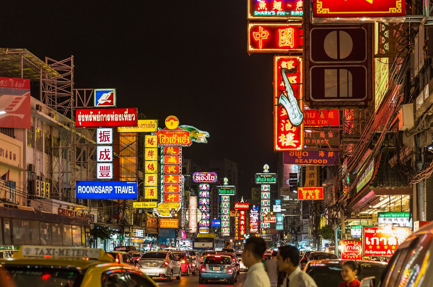 Yaowarat Road in Bangkok's Chinatown lit up at night with street food stalls