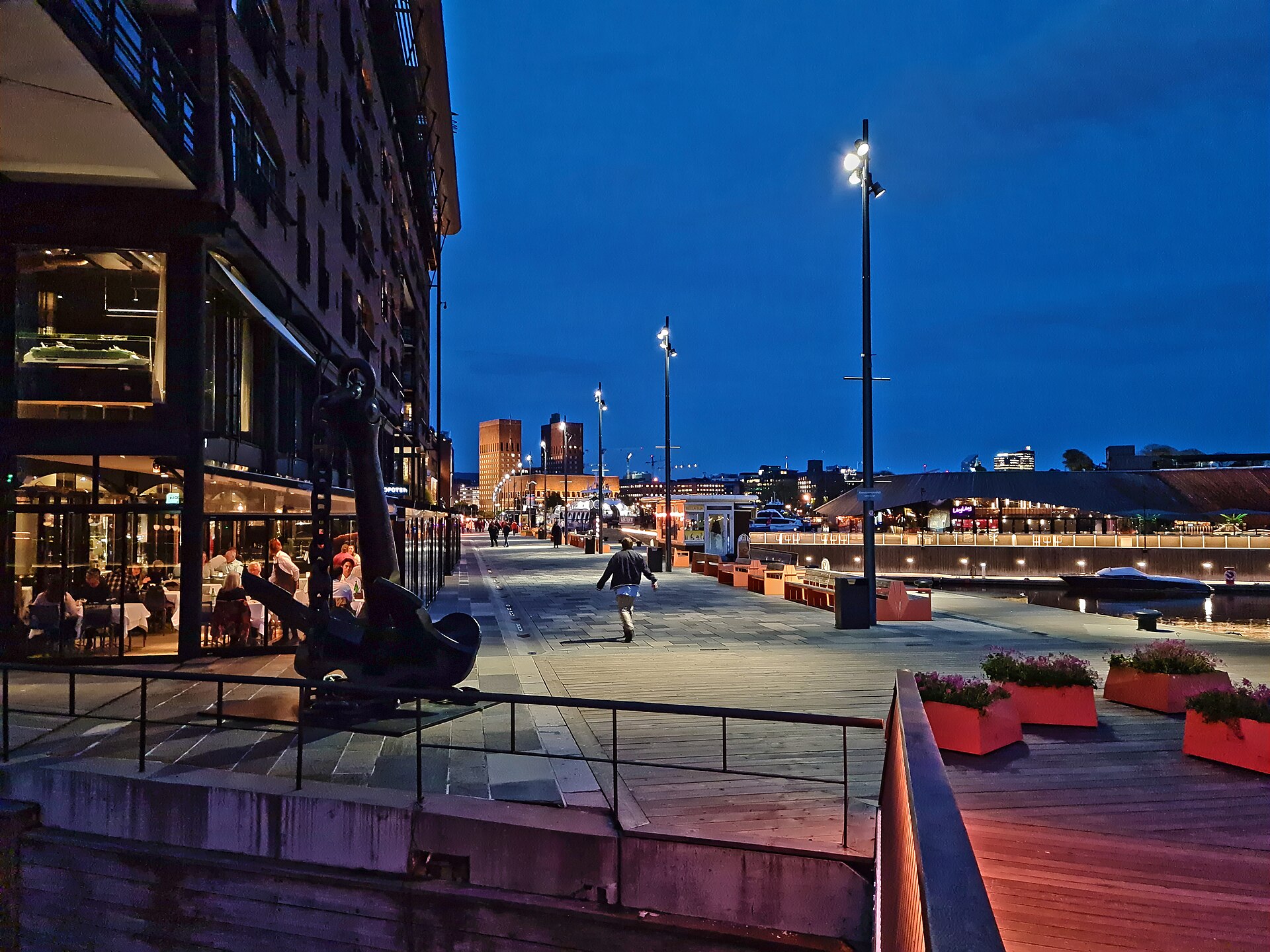 Aker Brygge waterfront promenade with Oslo City Hall across the bay