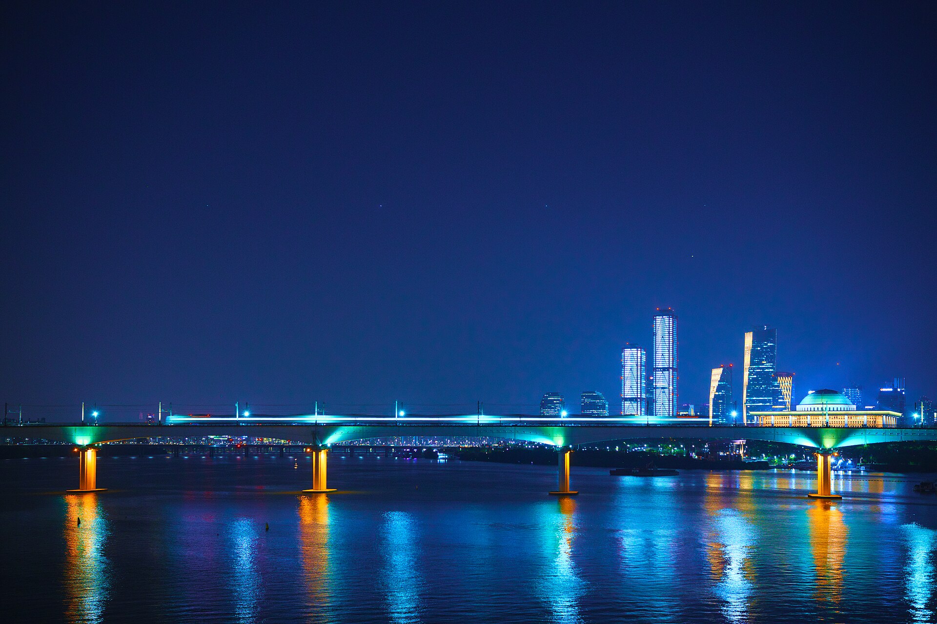 Han River in Seoul at night with illuminated Dangsan Railway Bridge