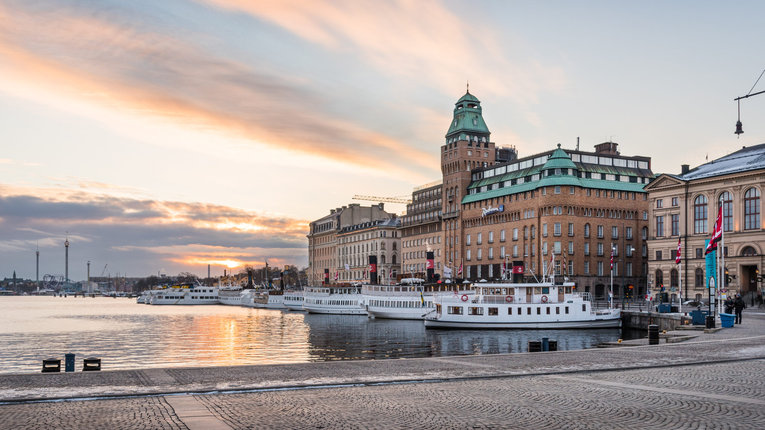 Archipelago ferries moored at Nybrokajen harbor in central Stockholm at sunset