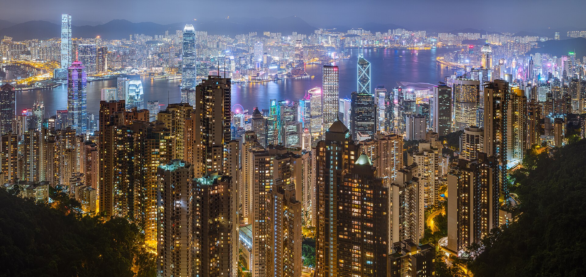 Victoria Harbour Hong Kong skyline at night with illuminated skyscrapers