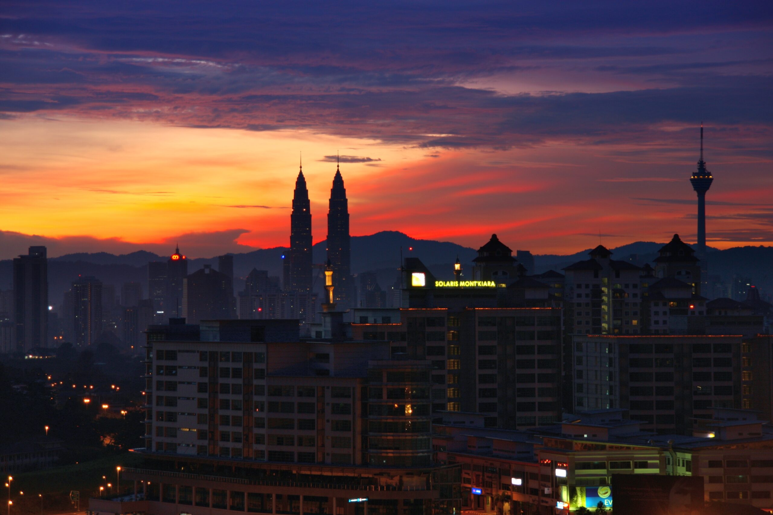 Kuala Lumpur sunrise skyline with the Petronas Towers and KL Tower