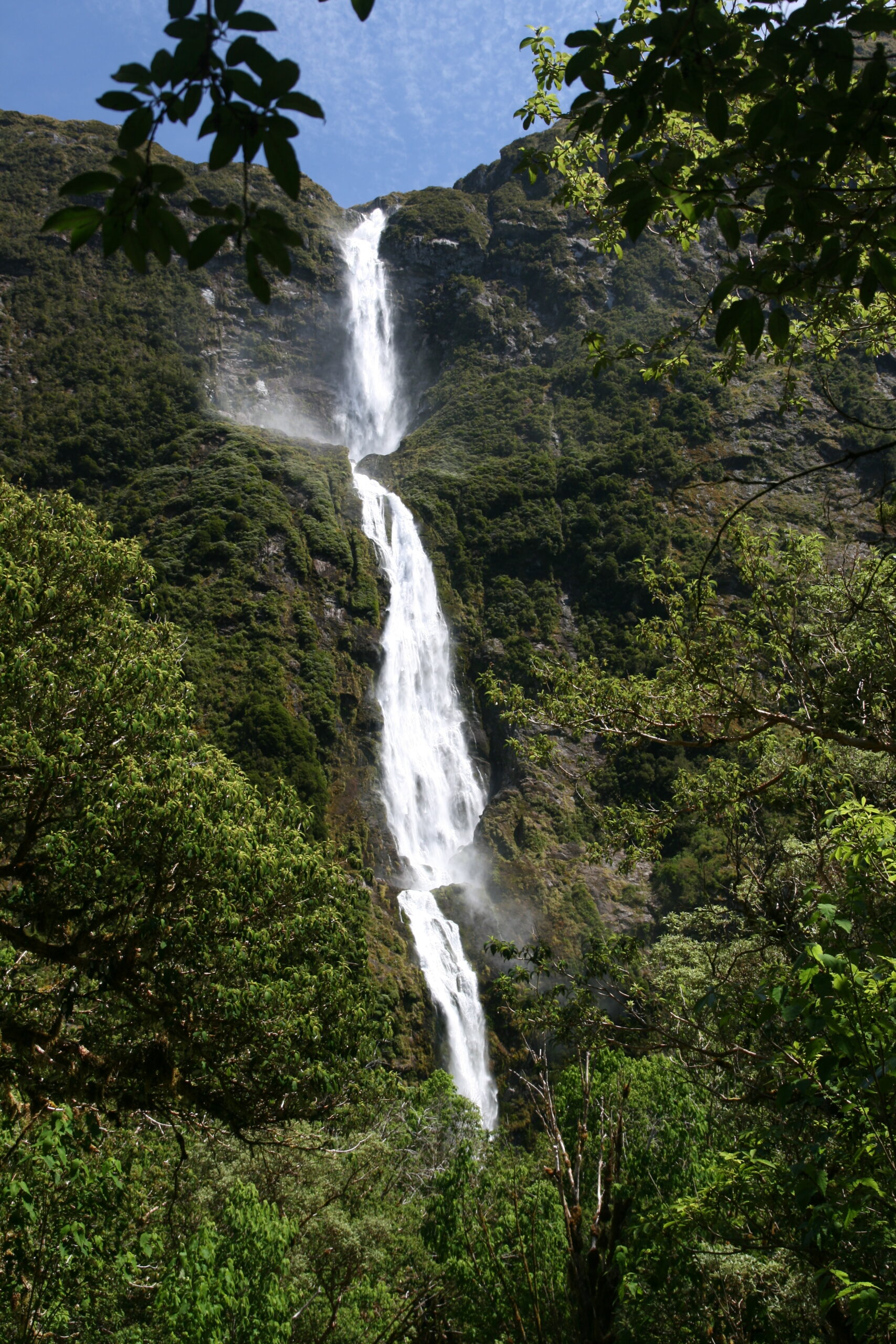 Milford Track waterfalls — Sutherland Falls plunging through Fiordland rainforest