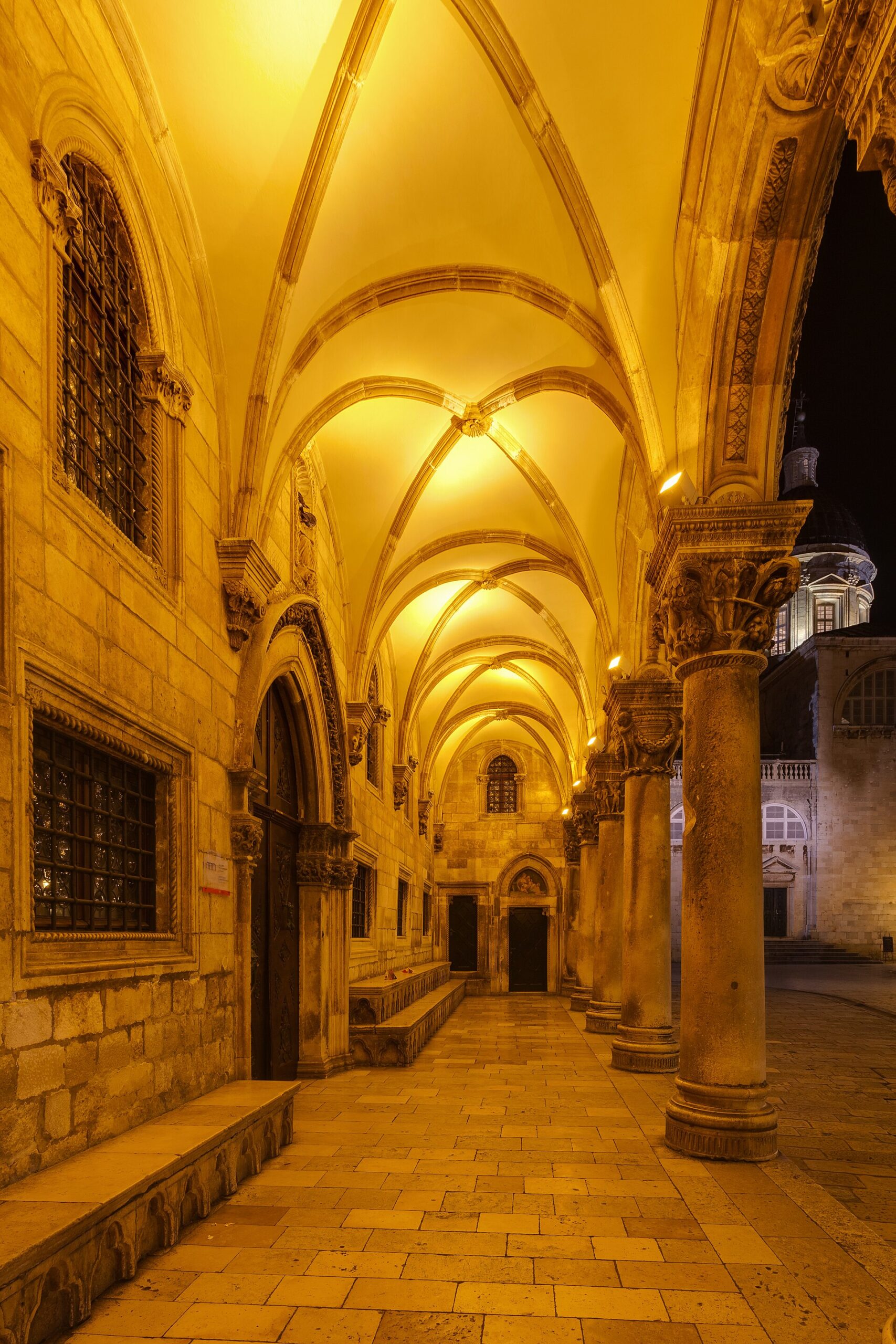 The Gothic-Renaissance loggia of the Rector's Palace lit up at night in Dubrovnik's Old Town