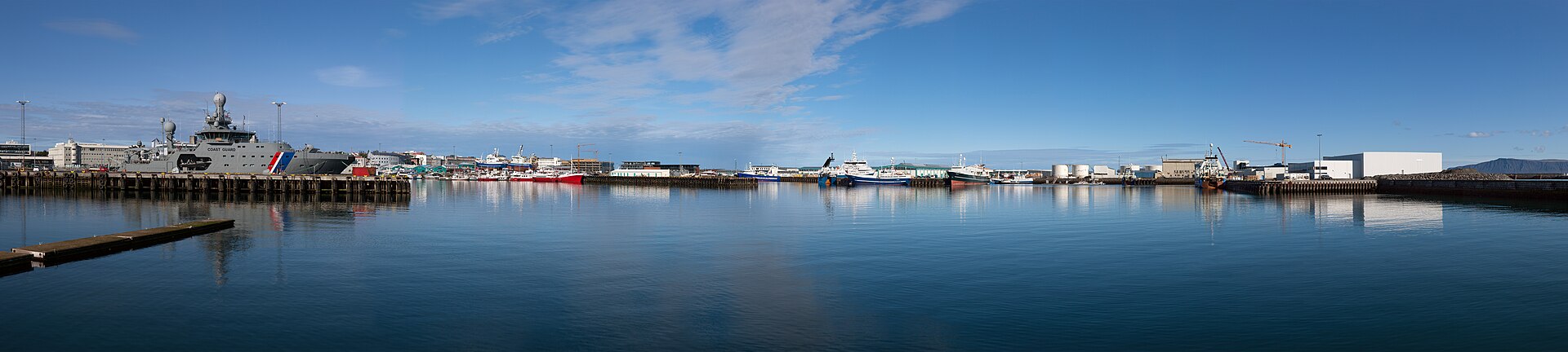 Reykjavik Old Harbor with boats and mountains behind
