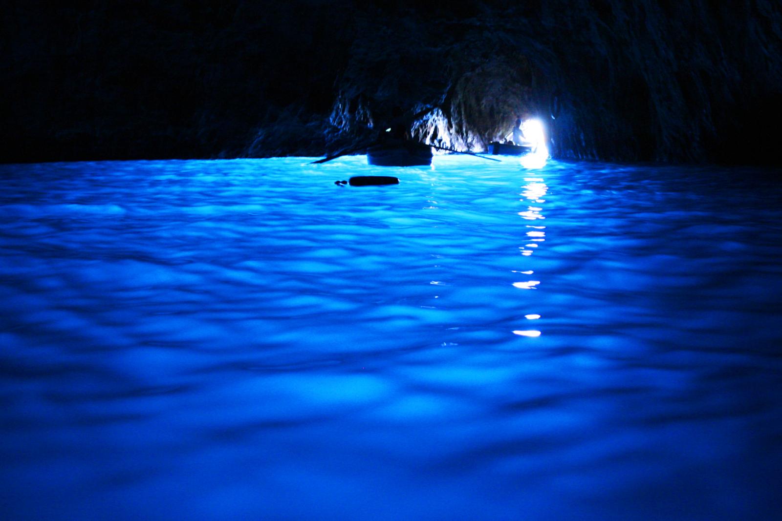 Amalfi Coast itinerary: rowboat inside the glowing Blue Grotto, Capri