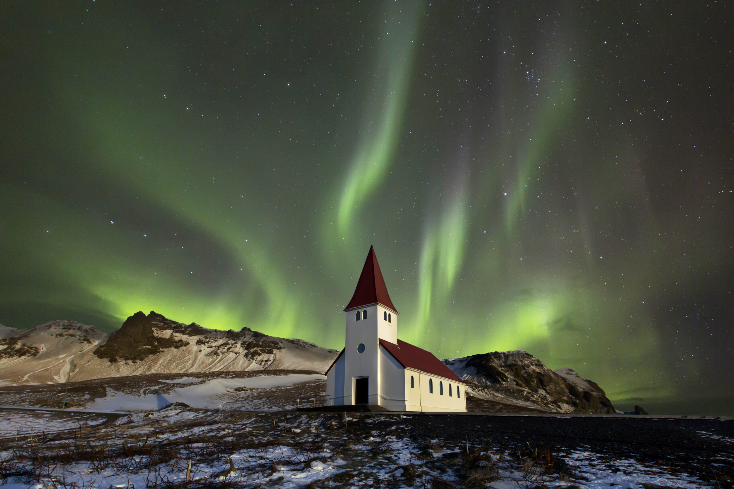 Aurora borealis over a church in Iceland