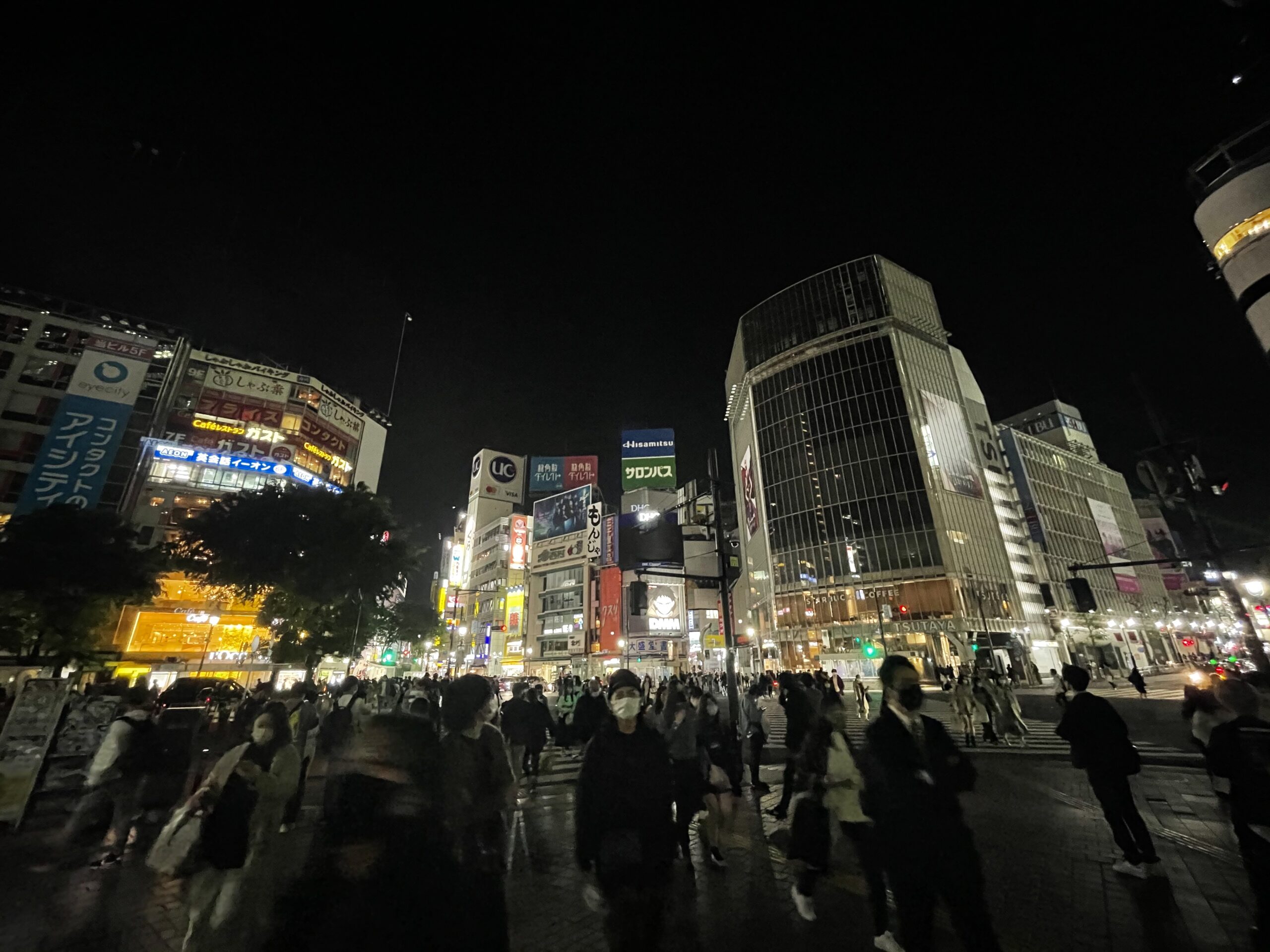 Tokyo Shibuya scramble crossing packed with pedestrians at night