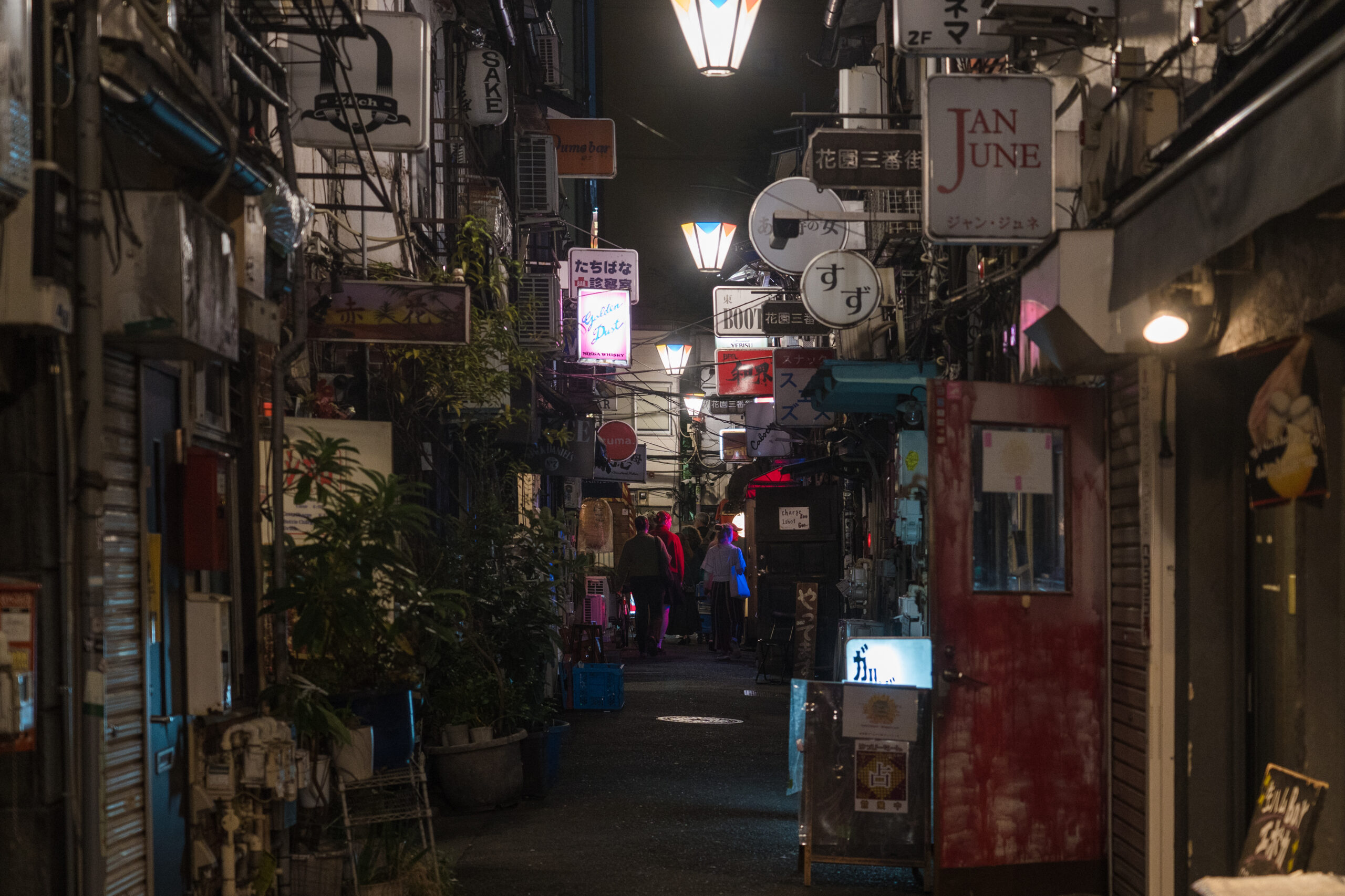 Shinjuku Golden Gai narrow bar alleys glowing at night in Tokyo