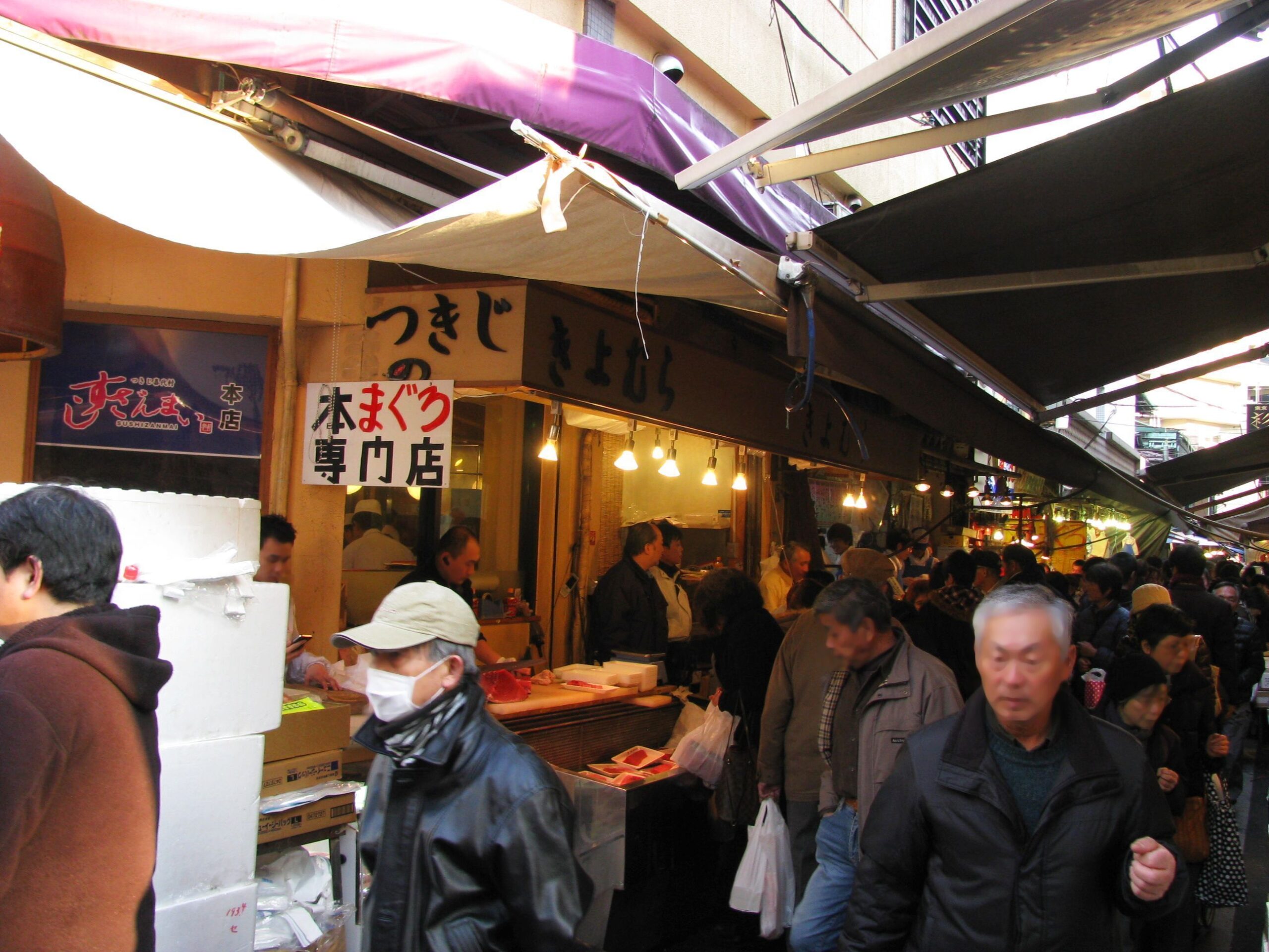 Tsukiji outer market food stalls and shoppers in Tokyo